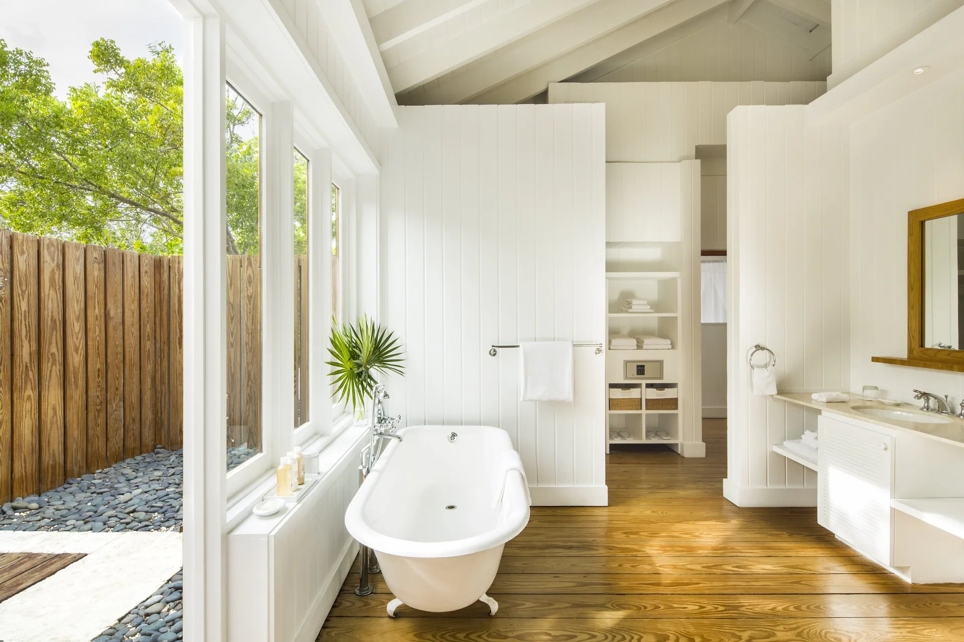 Beach House bathroom with freestanding tub and garden view at COMO Parrot Cay.