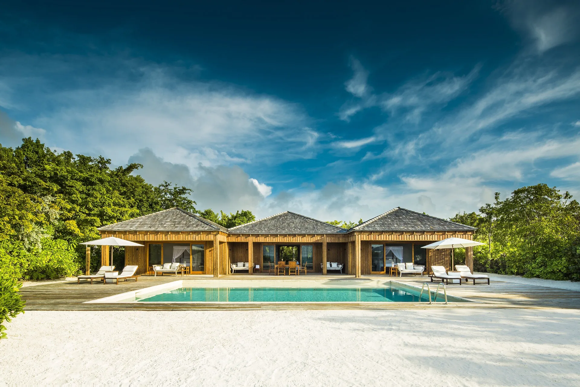 Beach House exterior with pool, terraces and beach sand at COMO Parrot Cay.