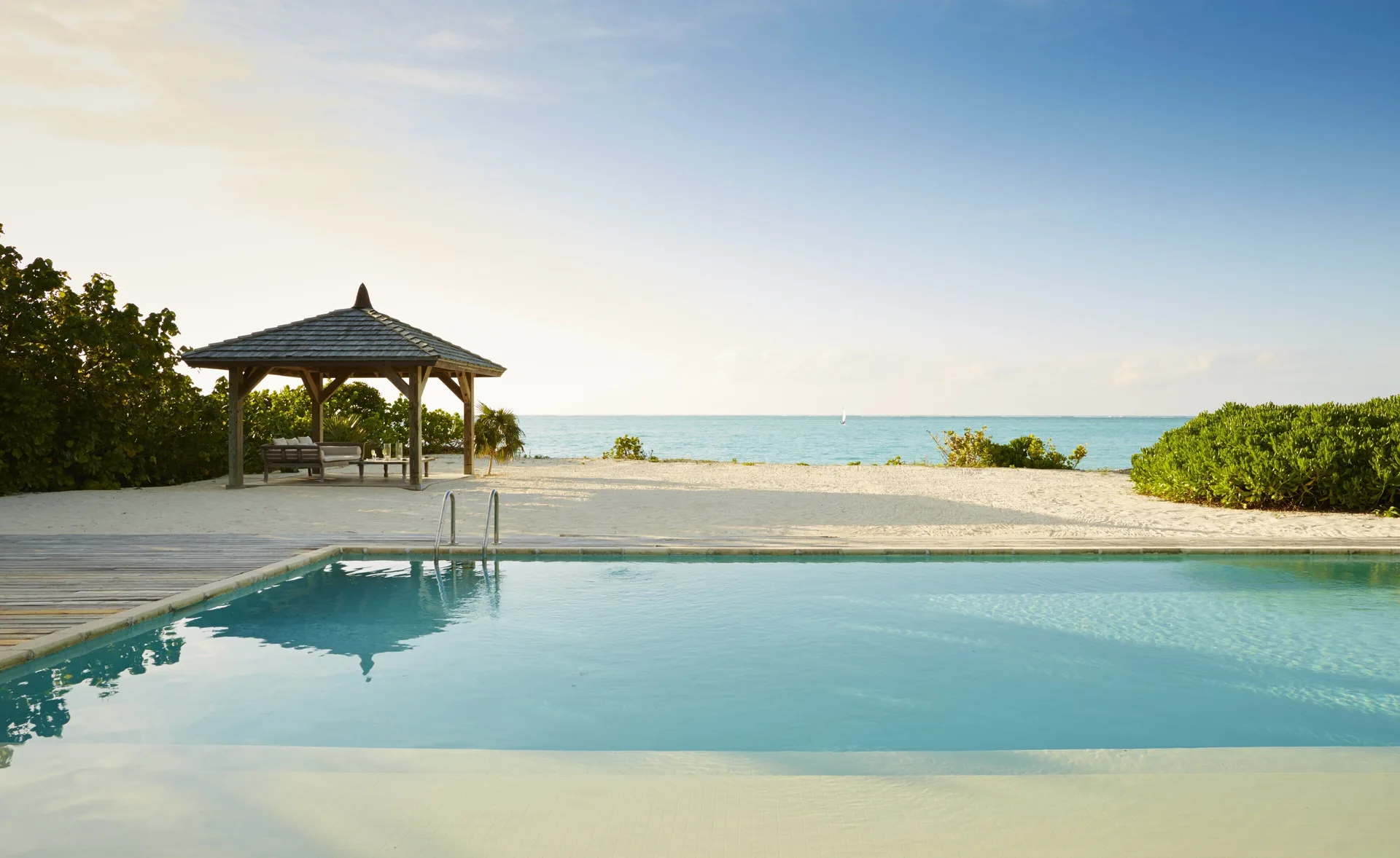 Beach House pool and shaded pavilion by the ocean at COMO Parrot Cay.