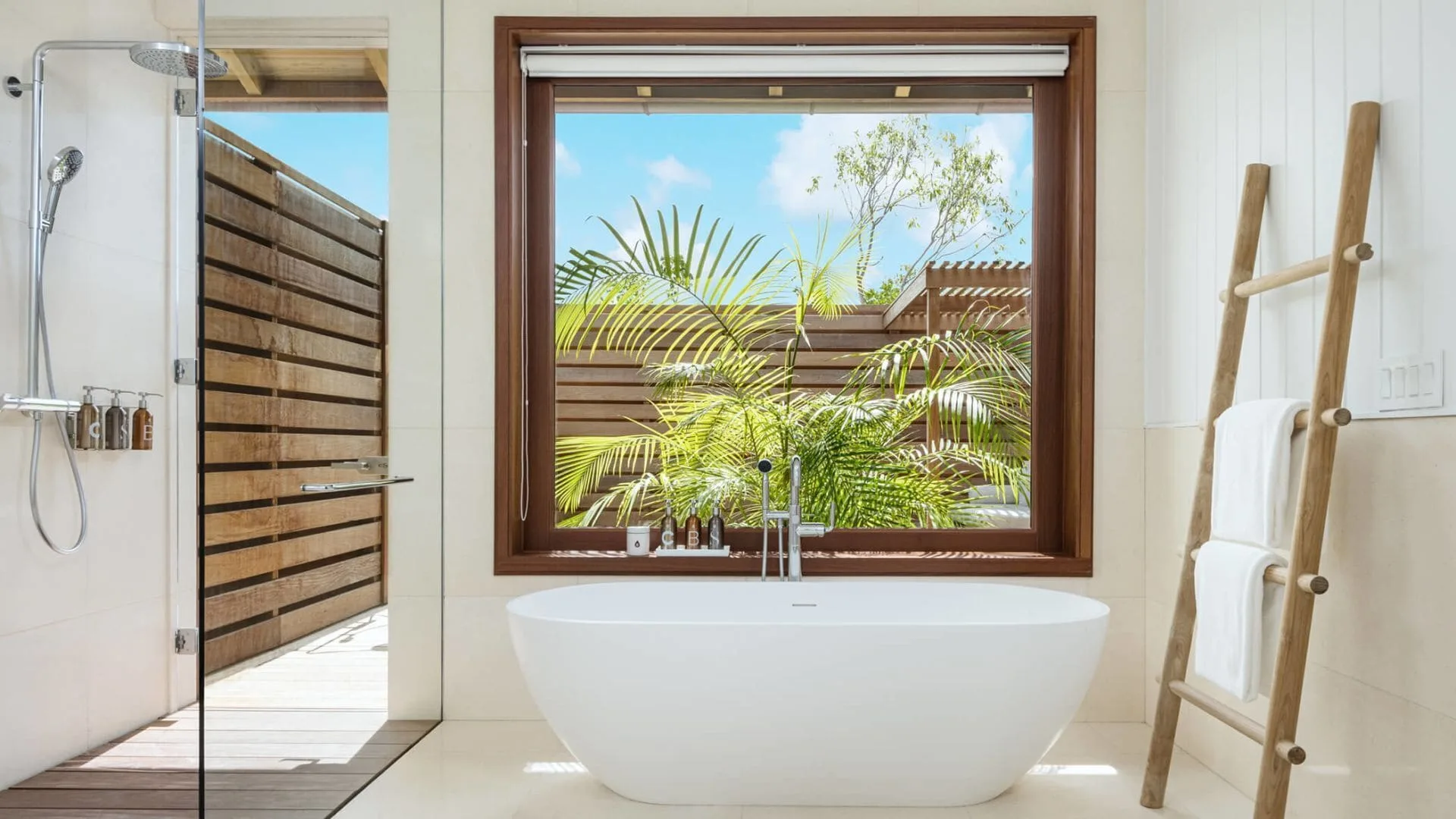 House beach bathroom with freestanding tub and outdoor shower at COMO Parrot Cay.