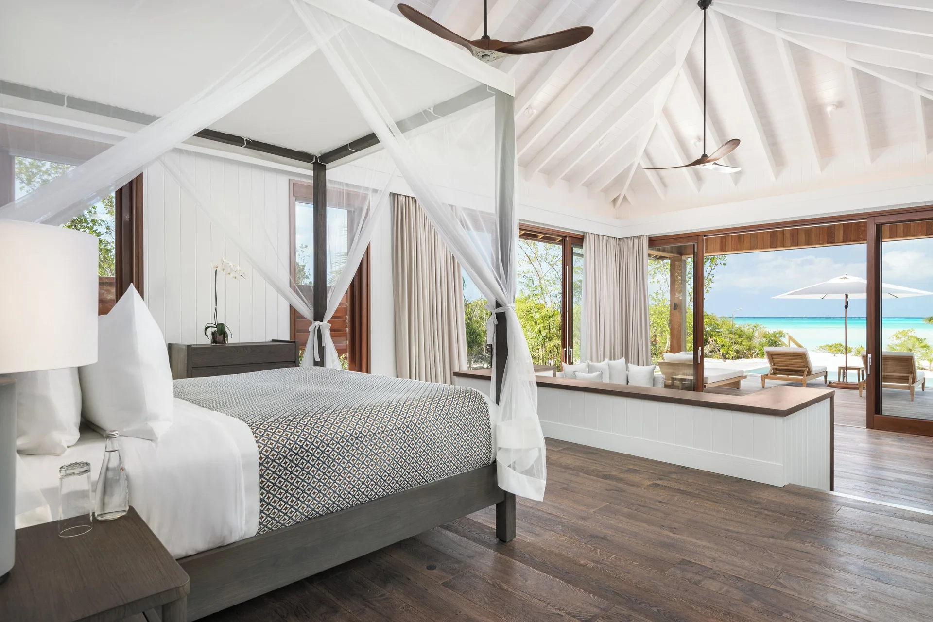 House beach bedroom with canopy king bed and terrace view at COMO Parrot Cay.