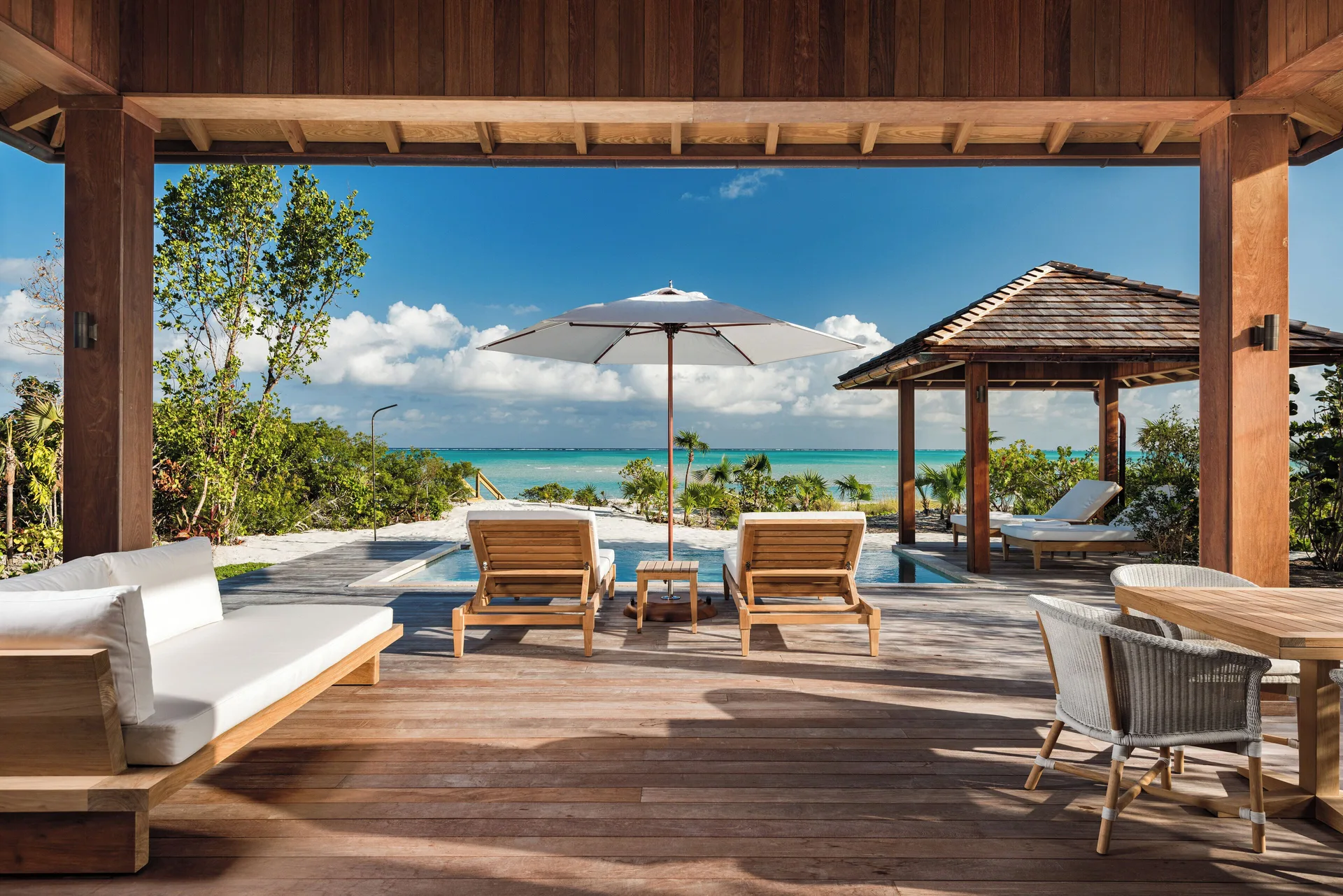 House beach terrace with pool, loungers and ocean view at COMO Parrot Cay.