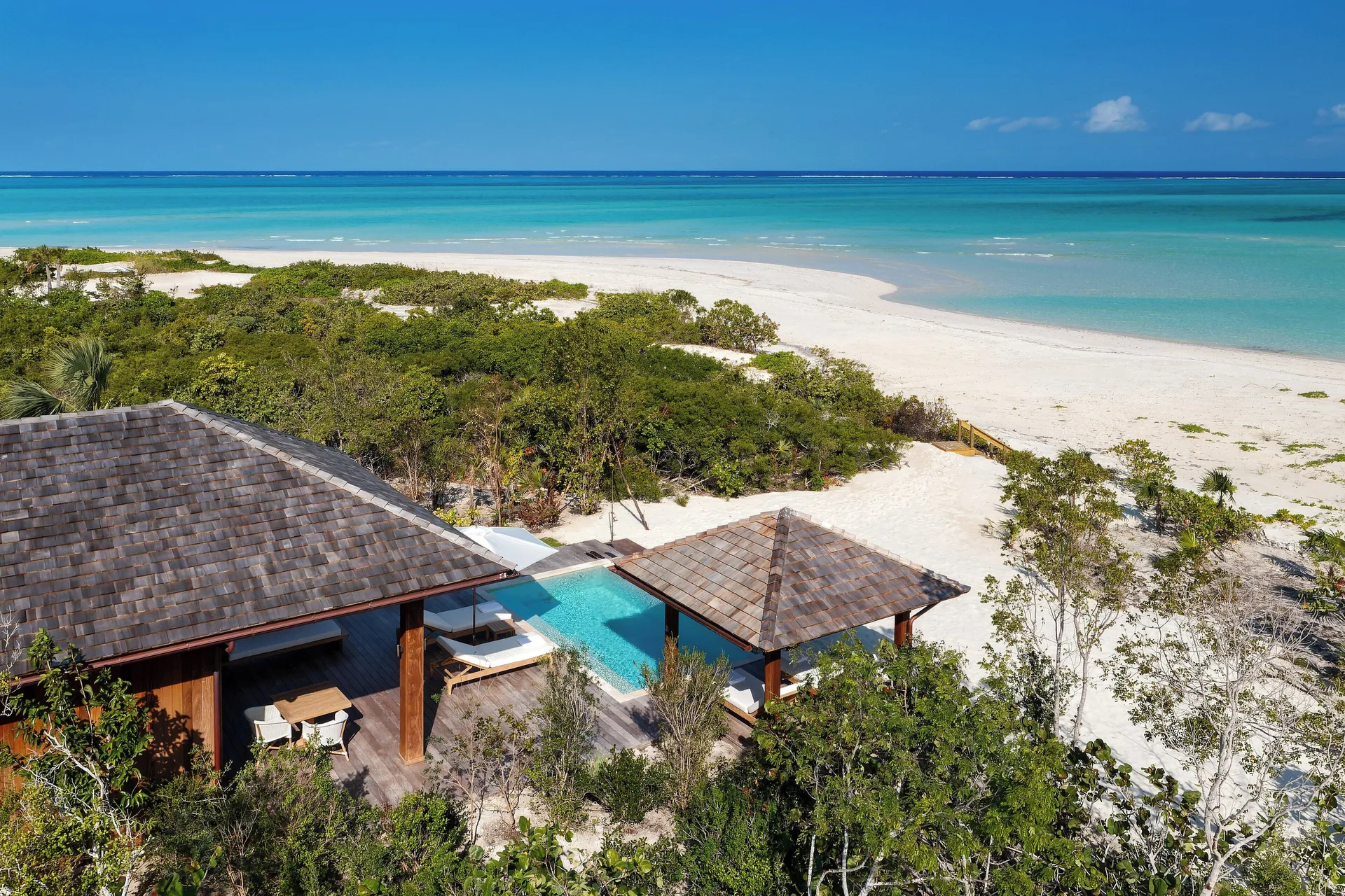 Aerial view of the House beach villa, pool and shoreline at COMO Parrot Cay.