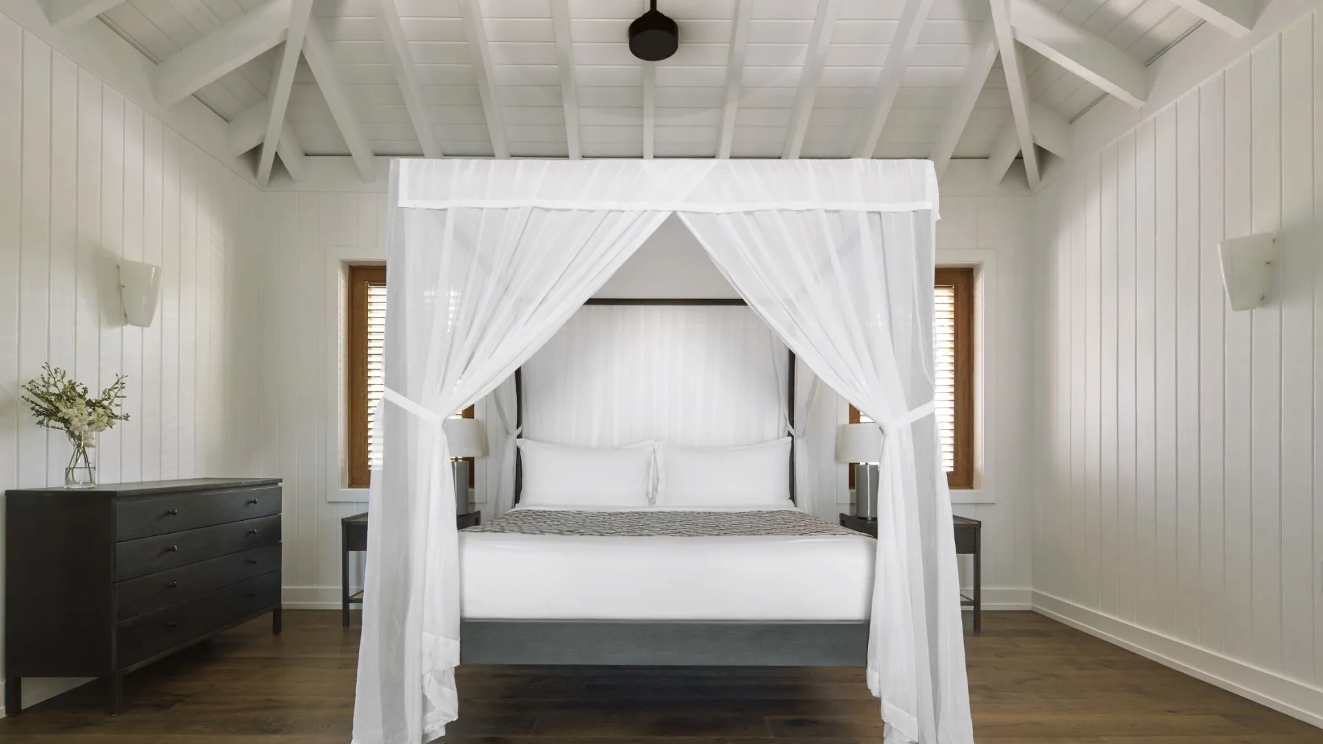 Beachfront Suite white canopy bed in a vaulted room at COMO Parrot Cay.