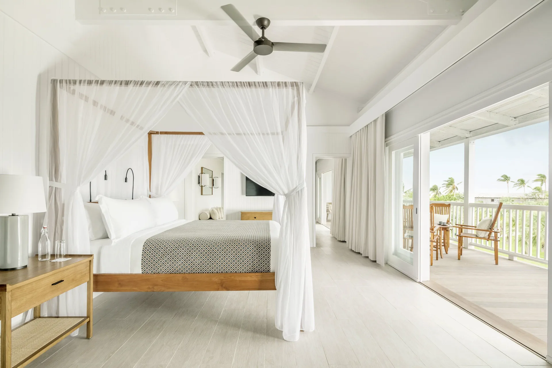 COMO Parrot Cay king bed with canopy netting and balcony doors at COMO Parrot Cay.