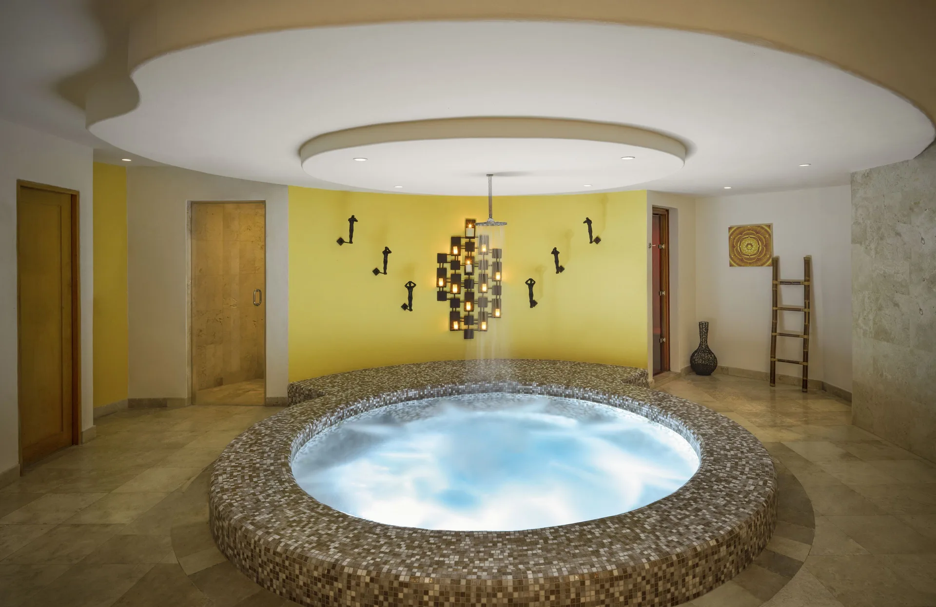 Circular indoor spa whirlpool with mosaic surround at Corazón Cabo.