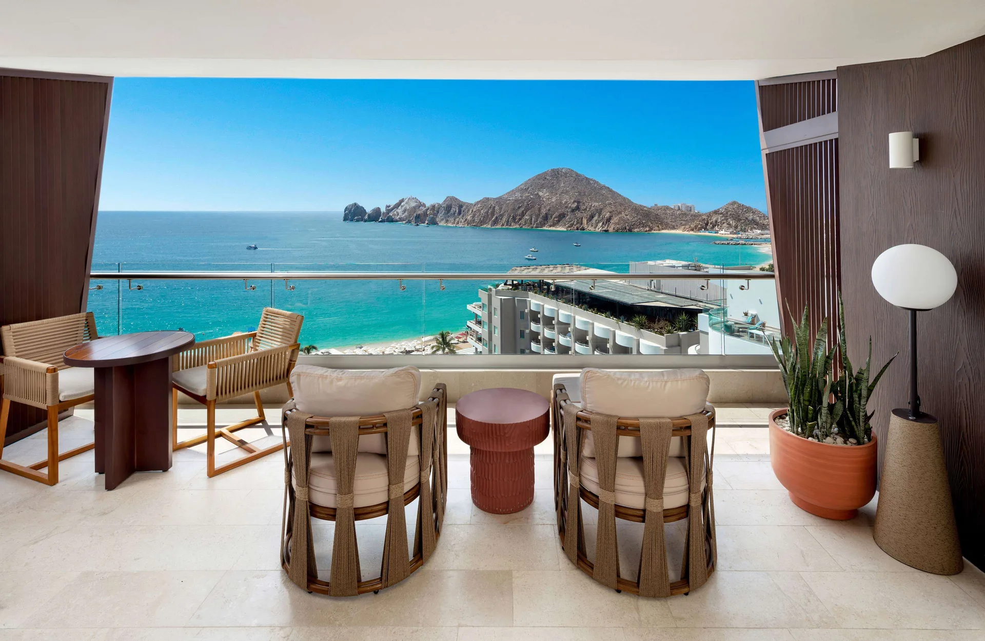 Infinity Ocean View balcony dining and lounge chairs at Corazón Cabo.