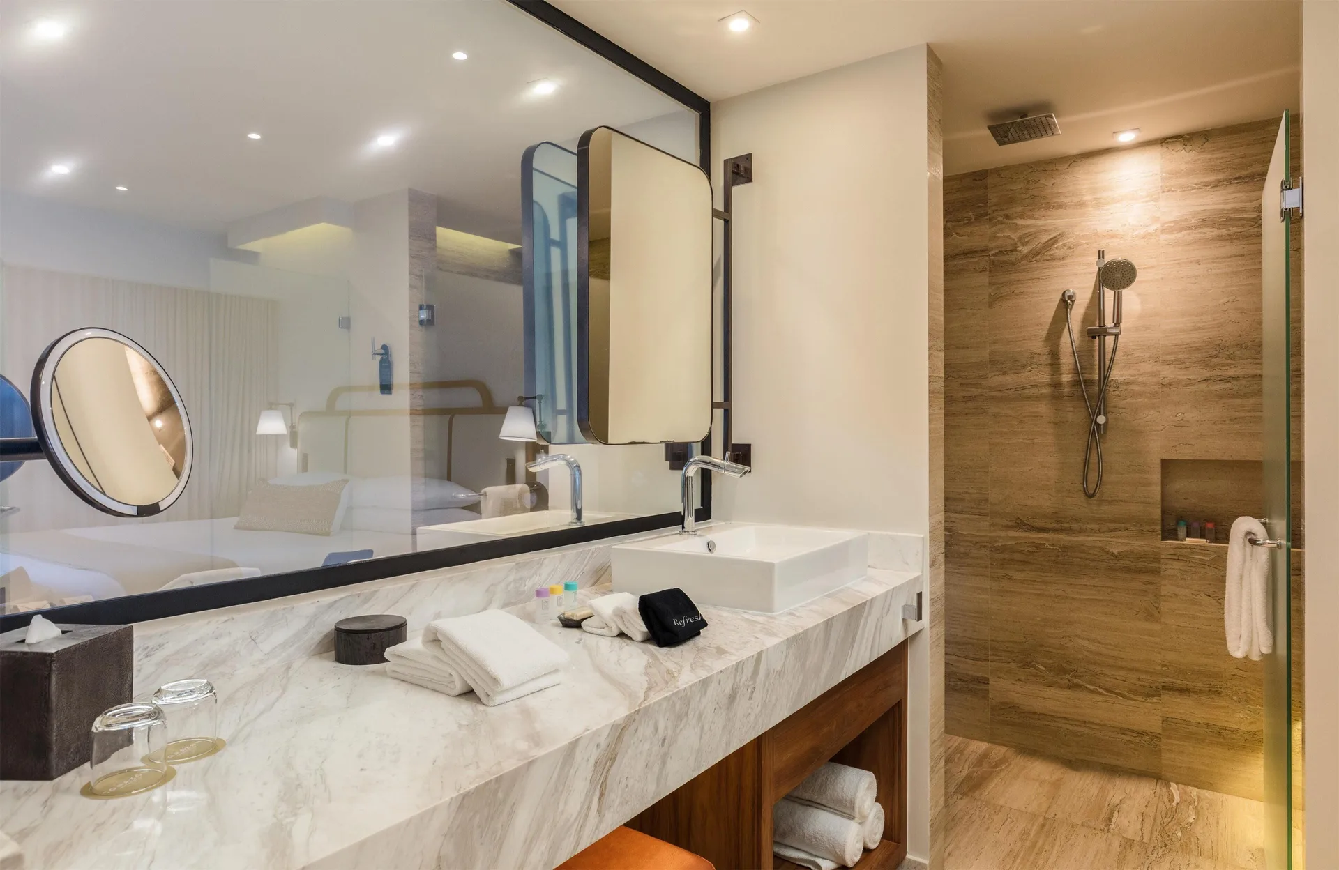 Infinity Ocean View bathroom vanity with shower and bedroom reflection at Corazón Cabo.