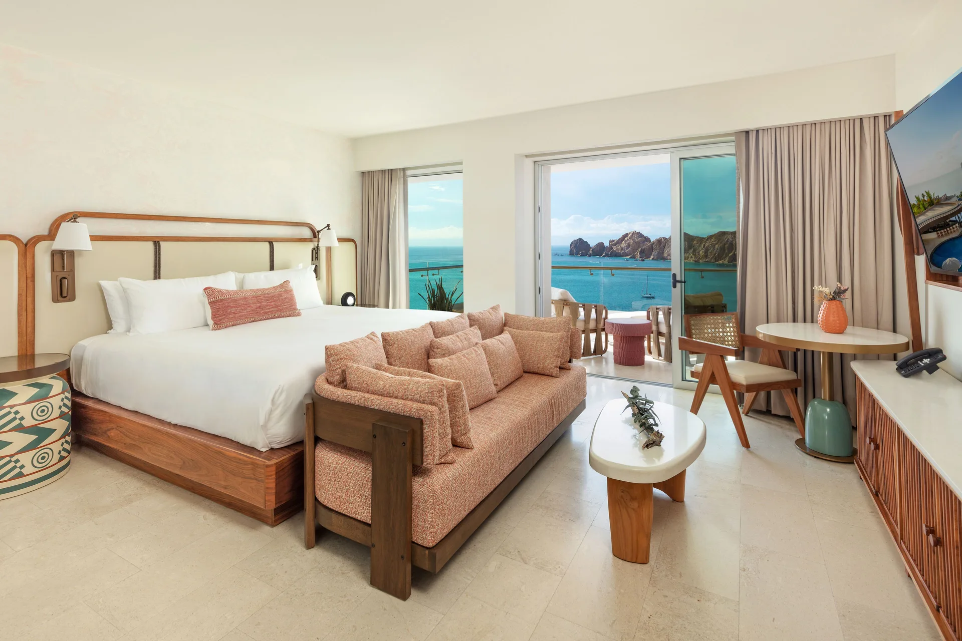 Infinity Ocean View king bed and sitting area with balcony at Corazón Cabo.