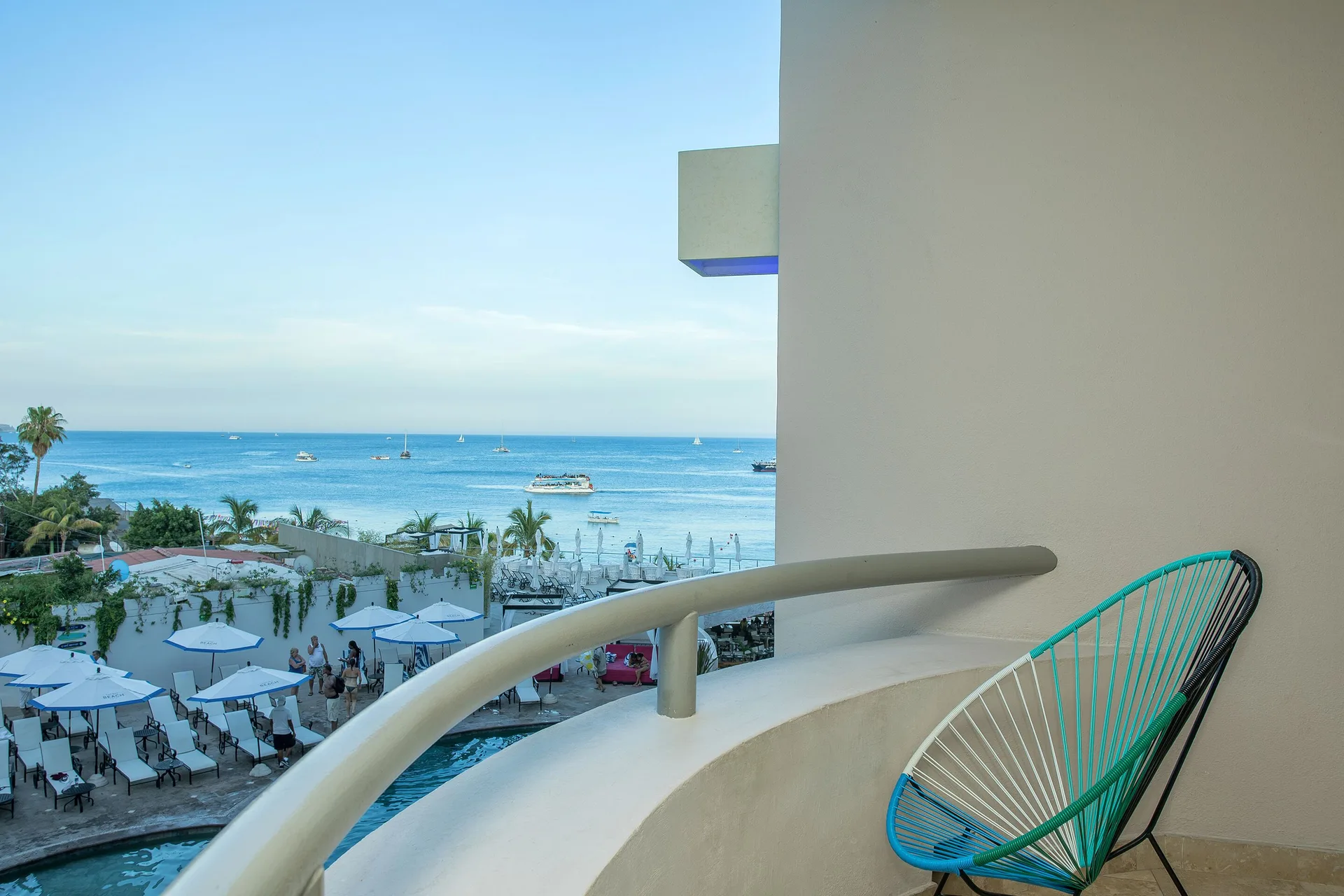 One Bedroom Deluxe balcony with ocean and pool views at Corazón Cabo.