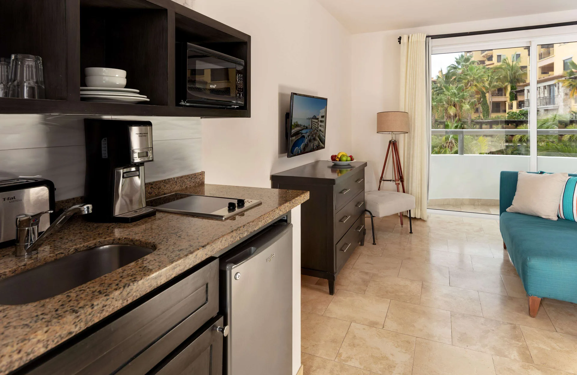 One Bedroom Deluxe kitchenette and sitting area with balcony at Corazón Cabo.