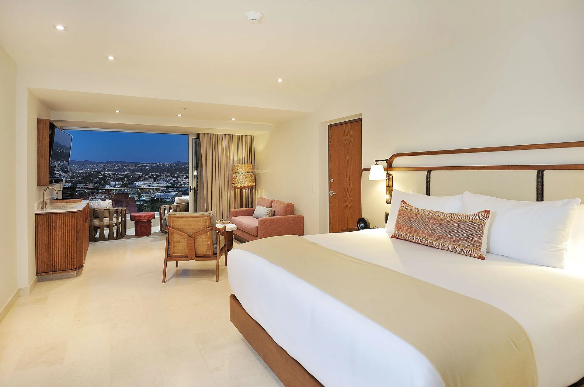 Infinity Sunset View king room with balcony and city lights at Corazón Cabo.