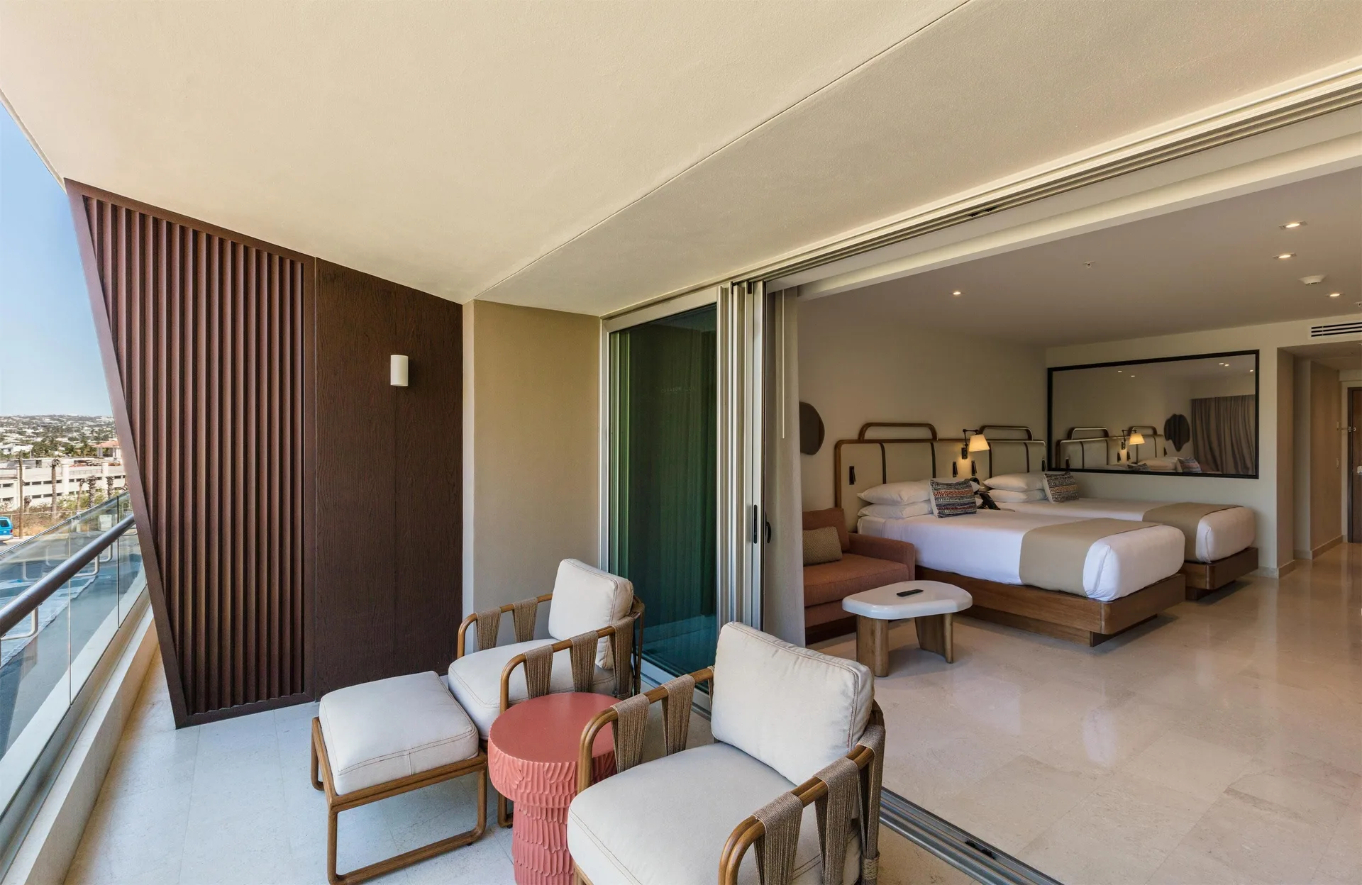 Balcony seating outside an Infinity Sunset View two-bed room at Corazón Cabo.