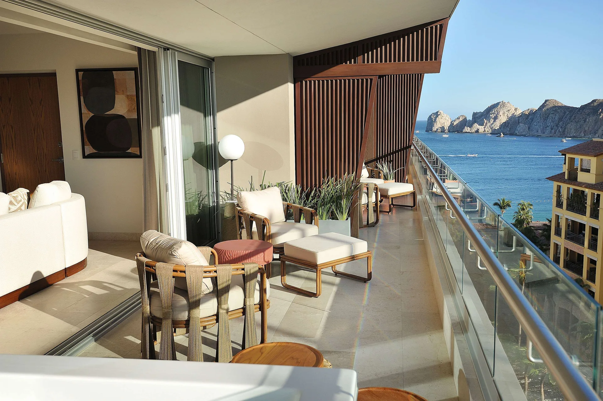 Three-bedroom suite balcony with lounge chairs and ocean view at Corazón Cabo.
