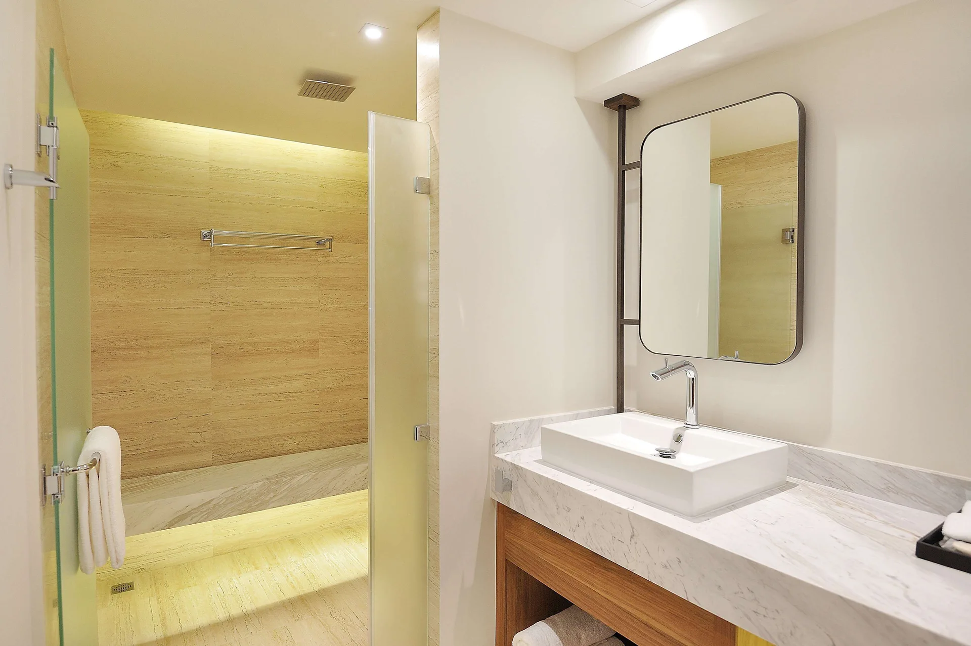 Three-bedroom suite bathroom with glass shower and vanity at Corazón Cabo.