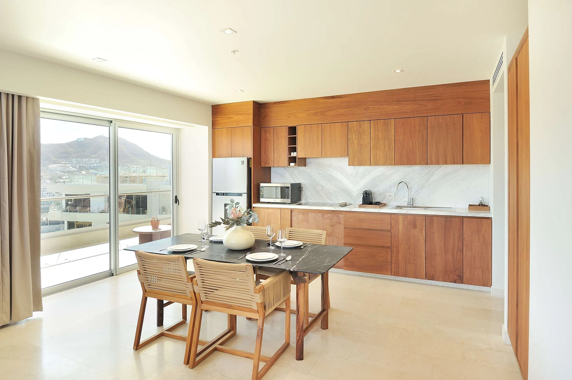 Three-bedroom suite dining table and kitchen area at Corazón Cabo.