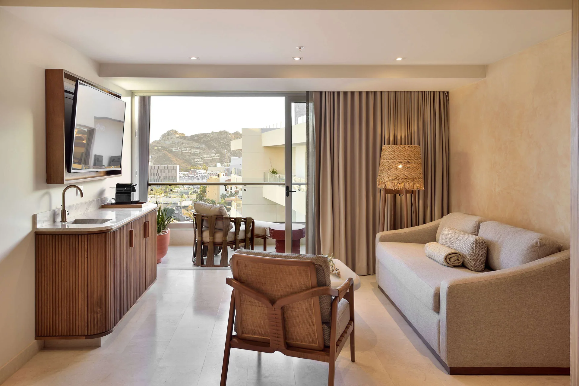 Three-bedroom suite sitting area with wet bar and balcony at Corazón Cabo.