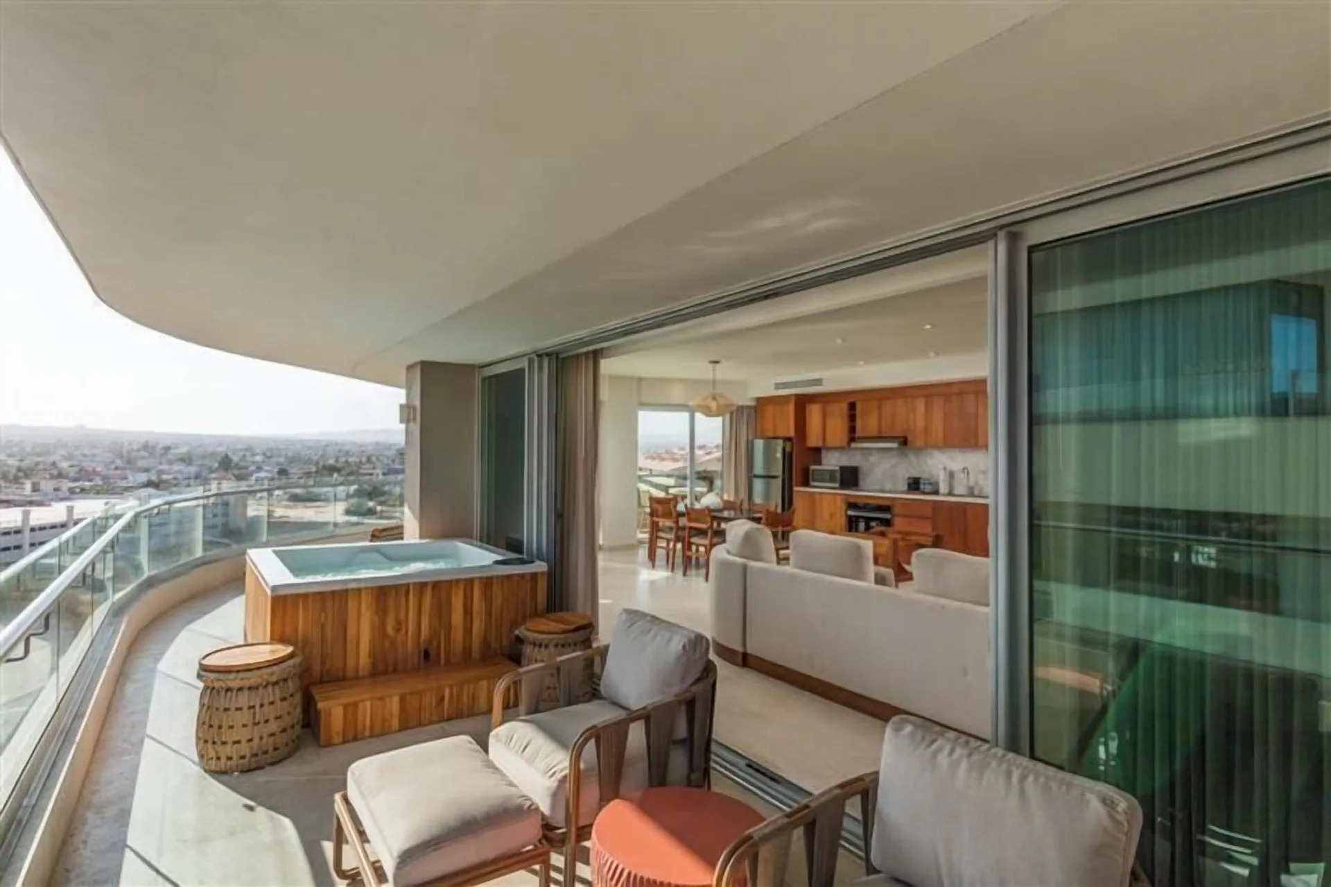 Three-bedroom suite balcony with hot tub and indoor living area at Corazón Cabo.