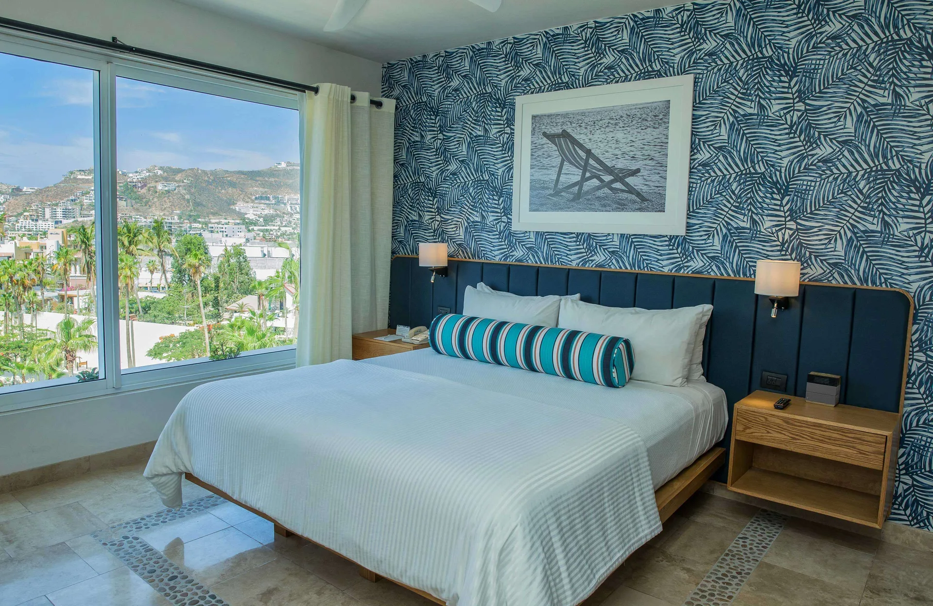 Three-bedroom suite bedroom with king bed and hillside view at Corazón Cabo.