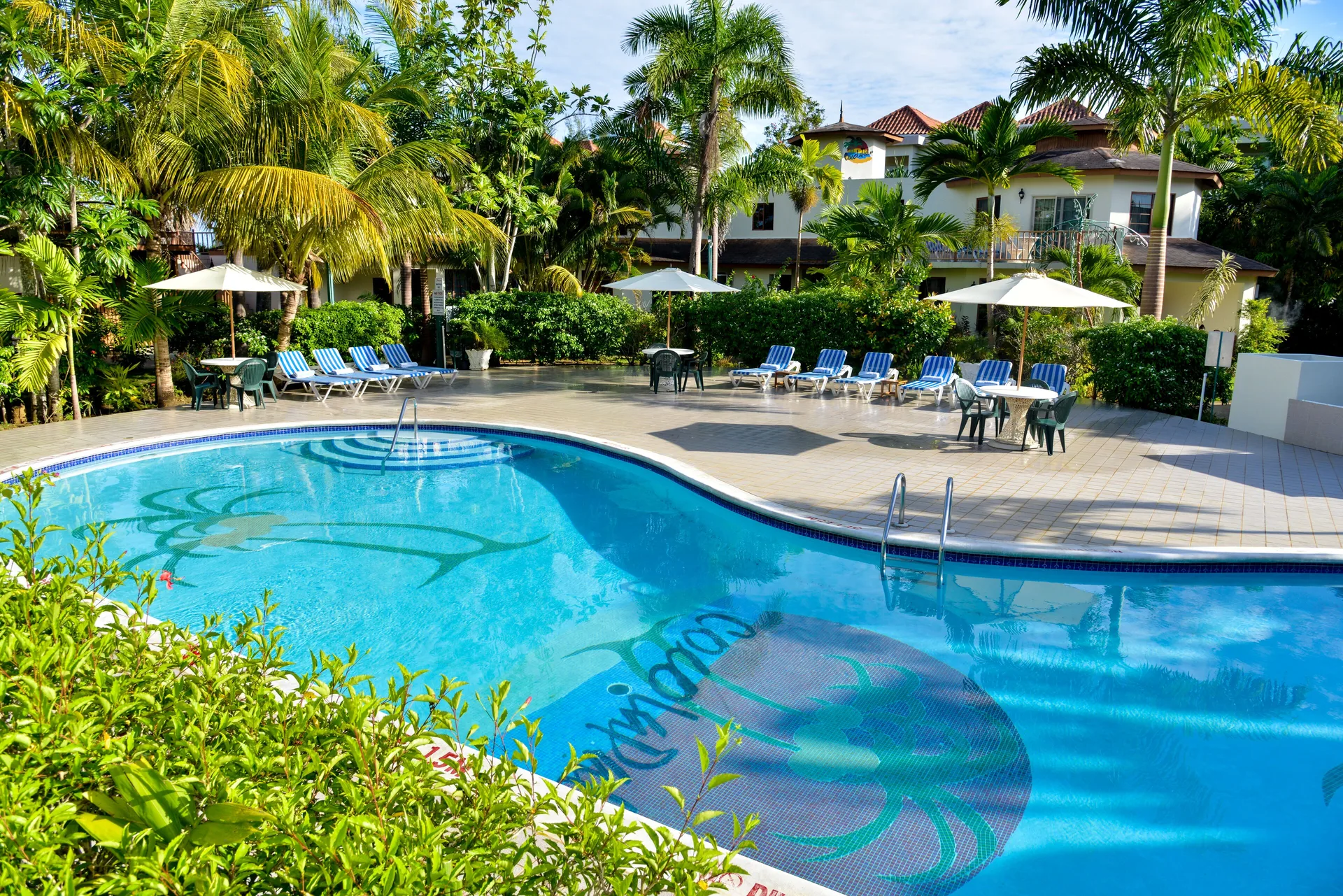 CocoLaPalm Seaside Resort casual beachfront hotel with tropical grounds, pools and Seven Mile Beach access