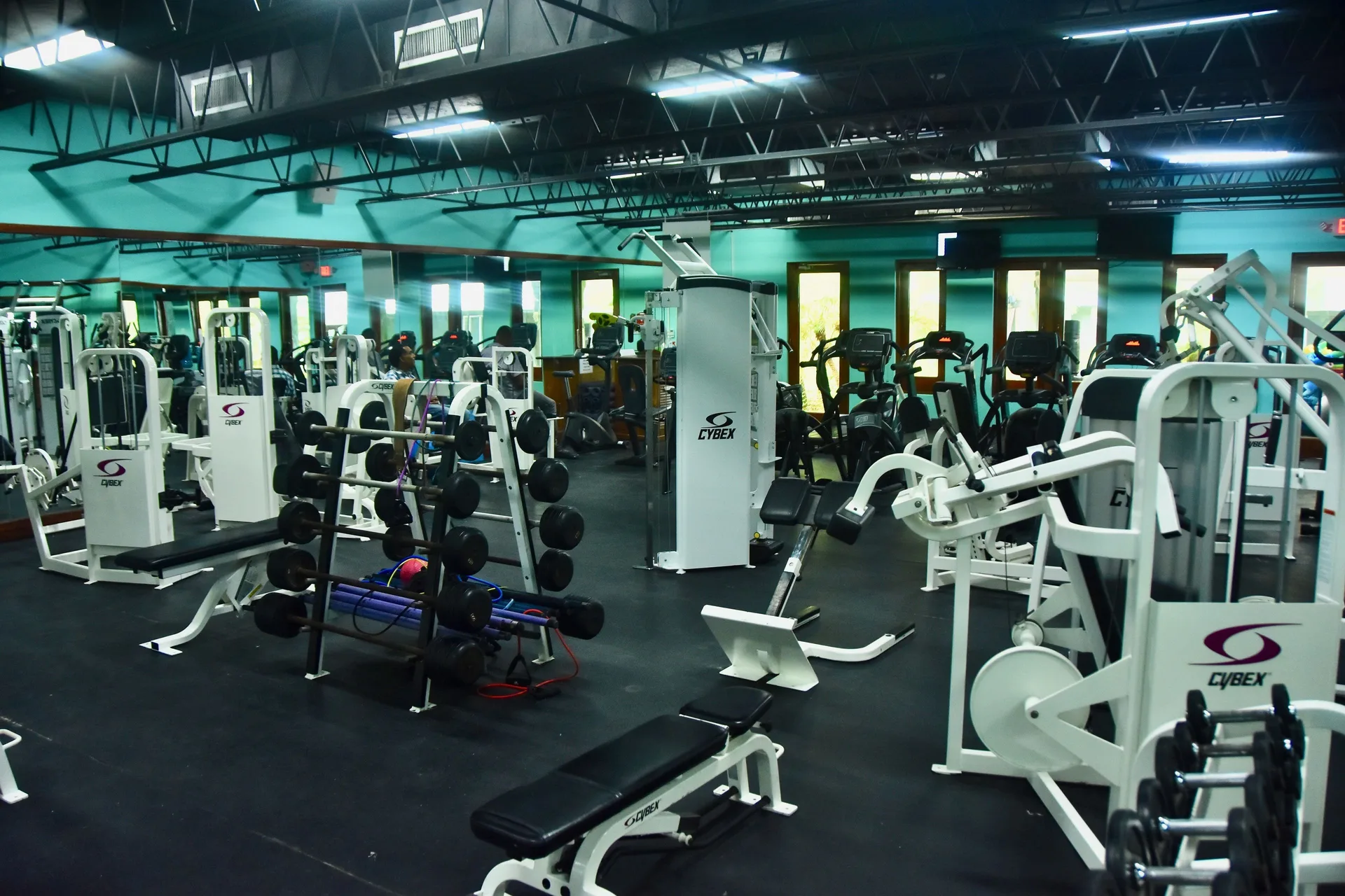 Fitness center with weight machines, benches, and cardio equipment at Couples Negril.