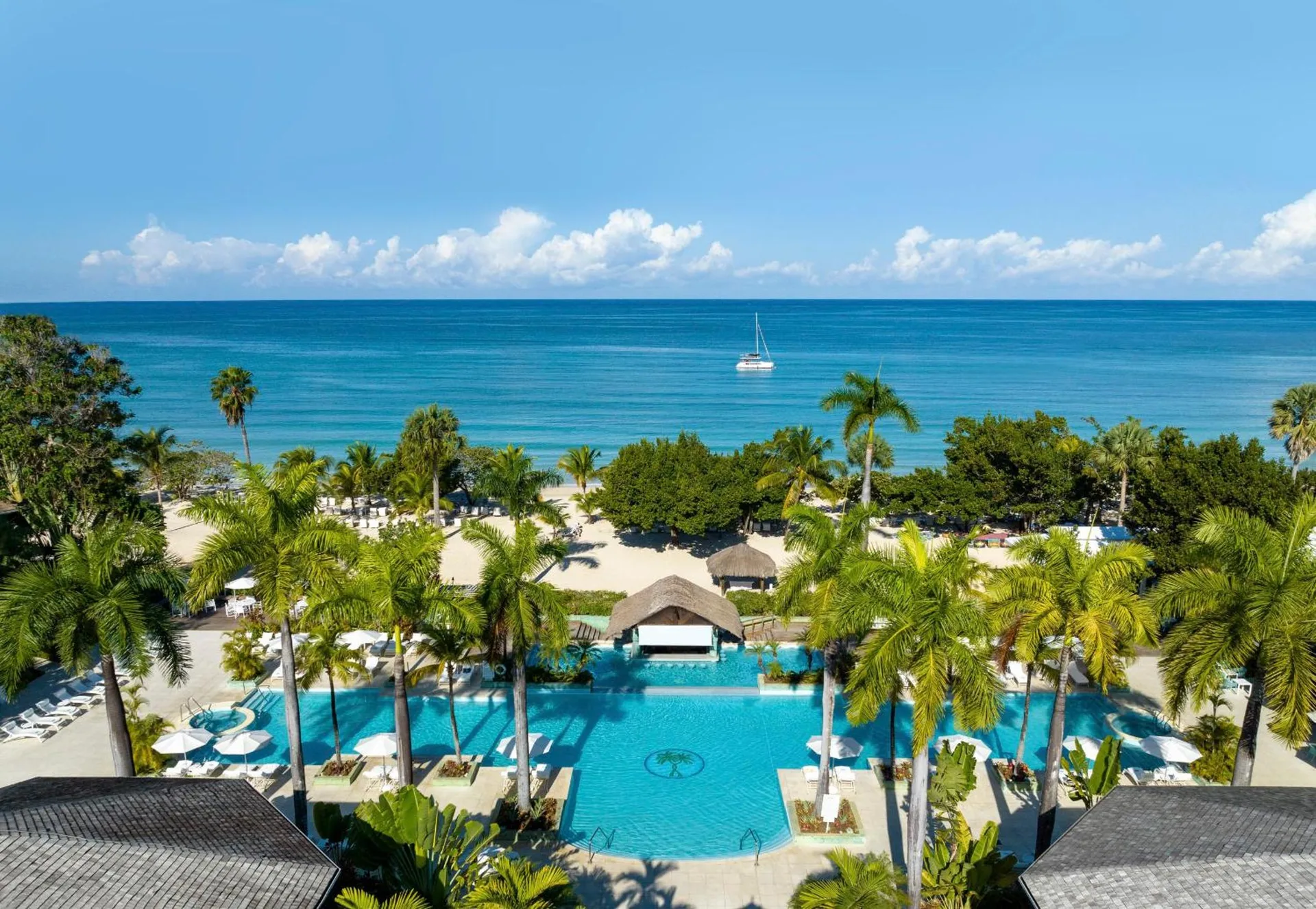 Elevated view of the pool, palms, beach, and sea at Couples Negril.