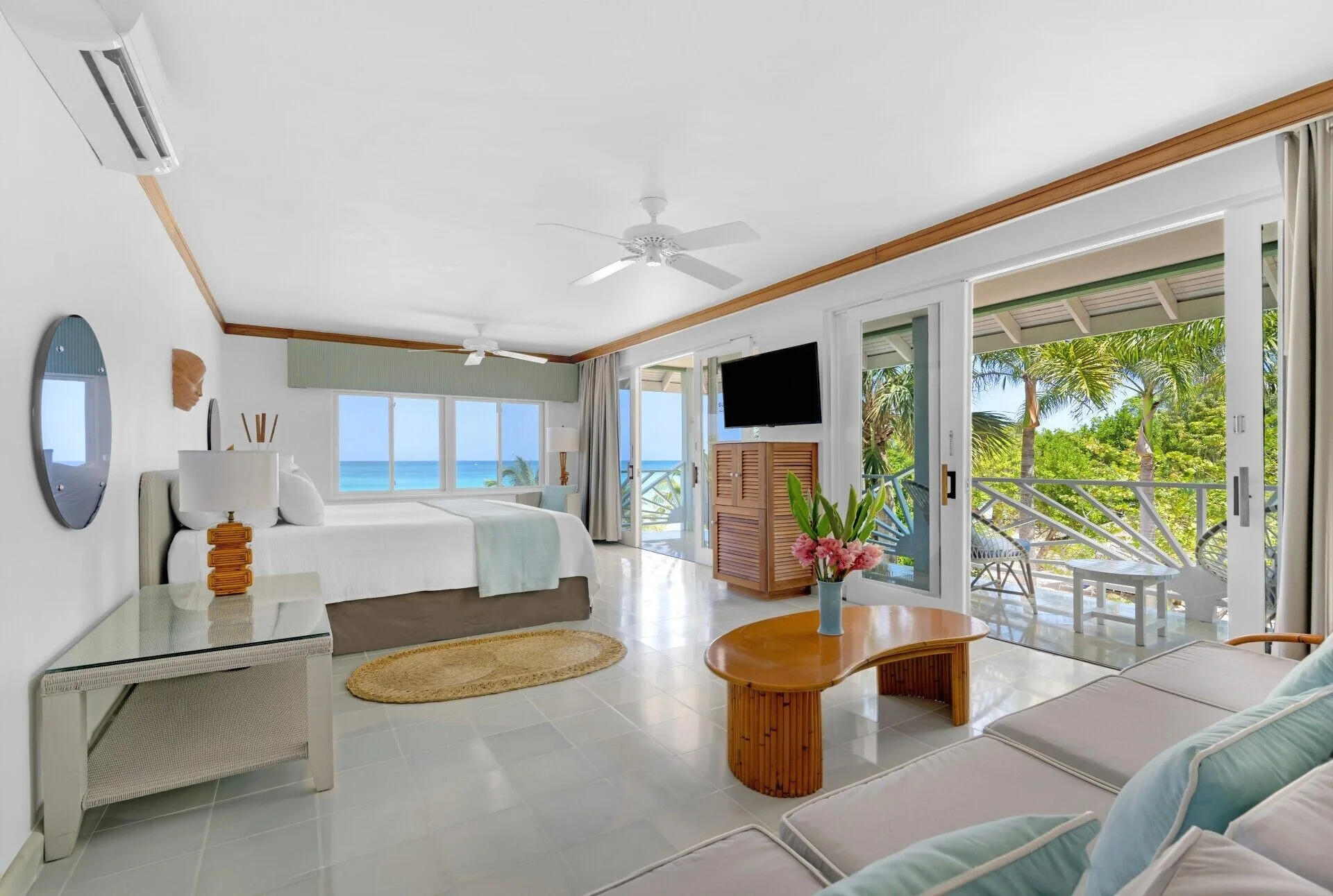 Beachfront Suite with king bed, lounge area, balcony doors, and ocean view at Couples Negril.