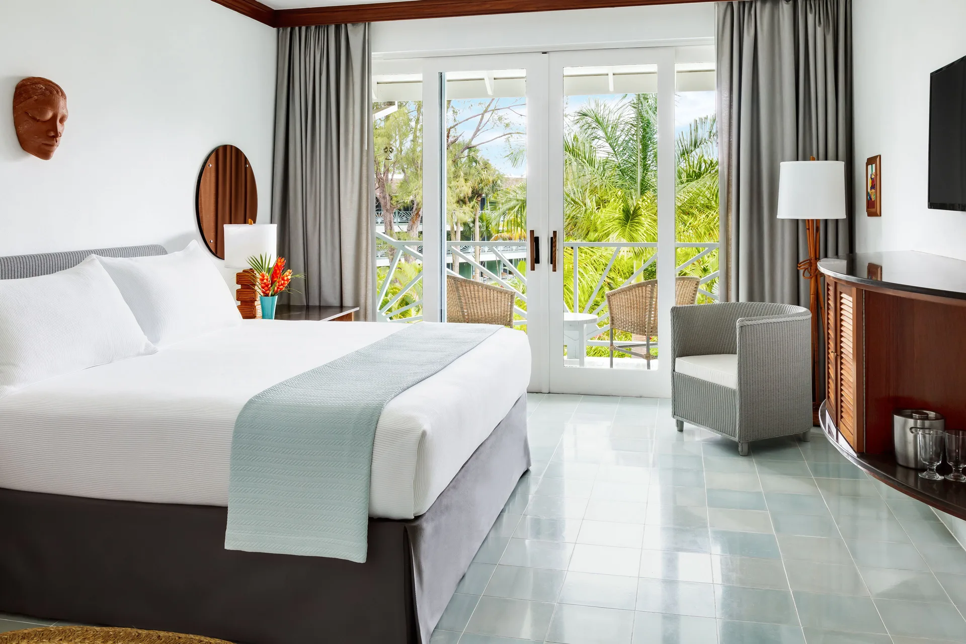 Deluxe Garden king bed guest room with balcony doors at Couples Negril.