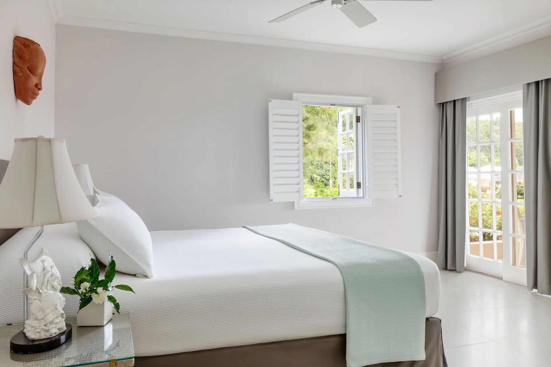 Beach Front Suite king bed and bright windows at Couples Sans Souci.