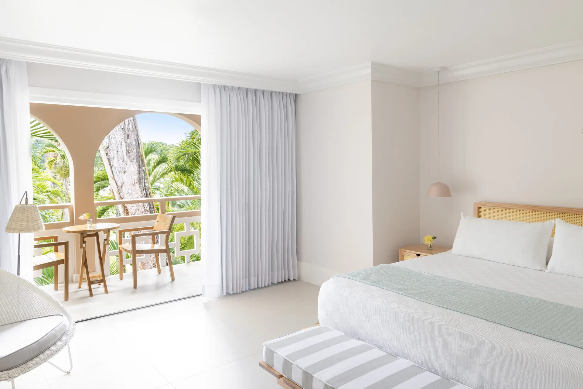Deluxe Garden Suite king bed and balcony seating at Couples Sans Souci.