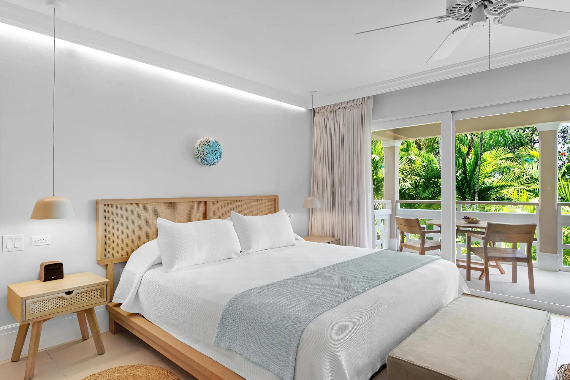 Deluxe Garden Suite king bed with sliding doors to a garden balcony at Couples Sans Souci.