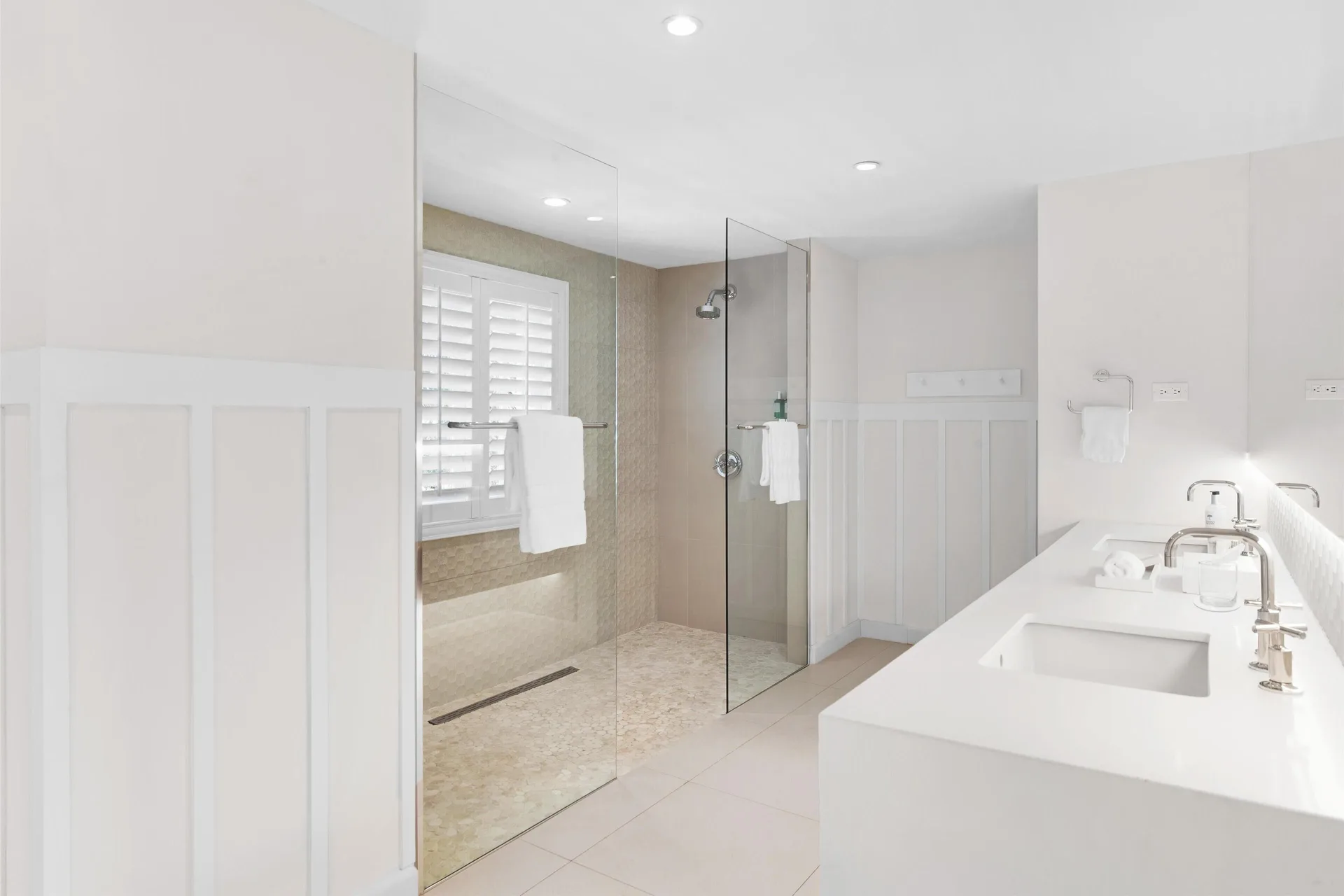 Deluxe Garden Suite bathroom with glass walk-in shower at Couples Sans Souci.