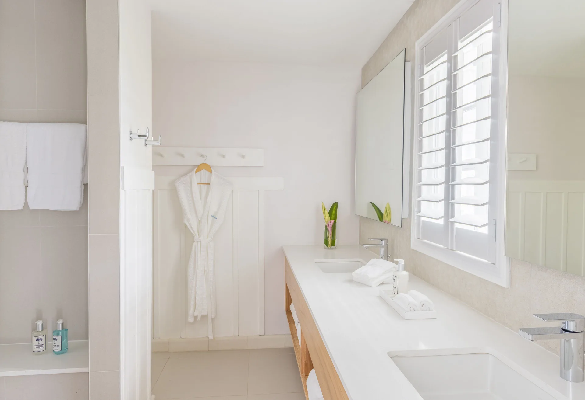 Penthouse Ocean Suite bathroom vanity and robe at Couples Sans Souci.