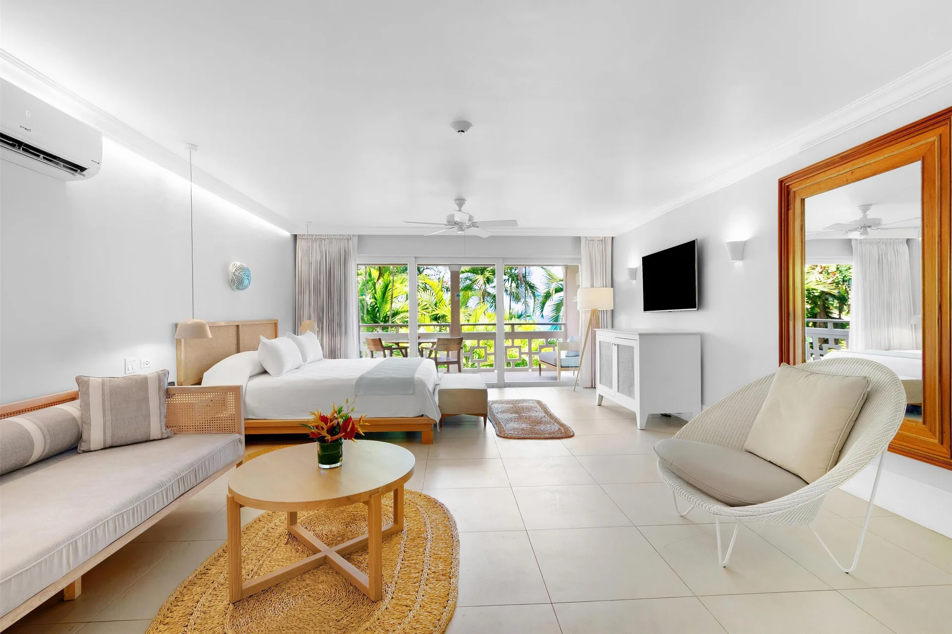 Penthouse Ocean Suite king bed and lounge area at Couples Sans Souci.
