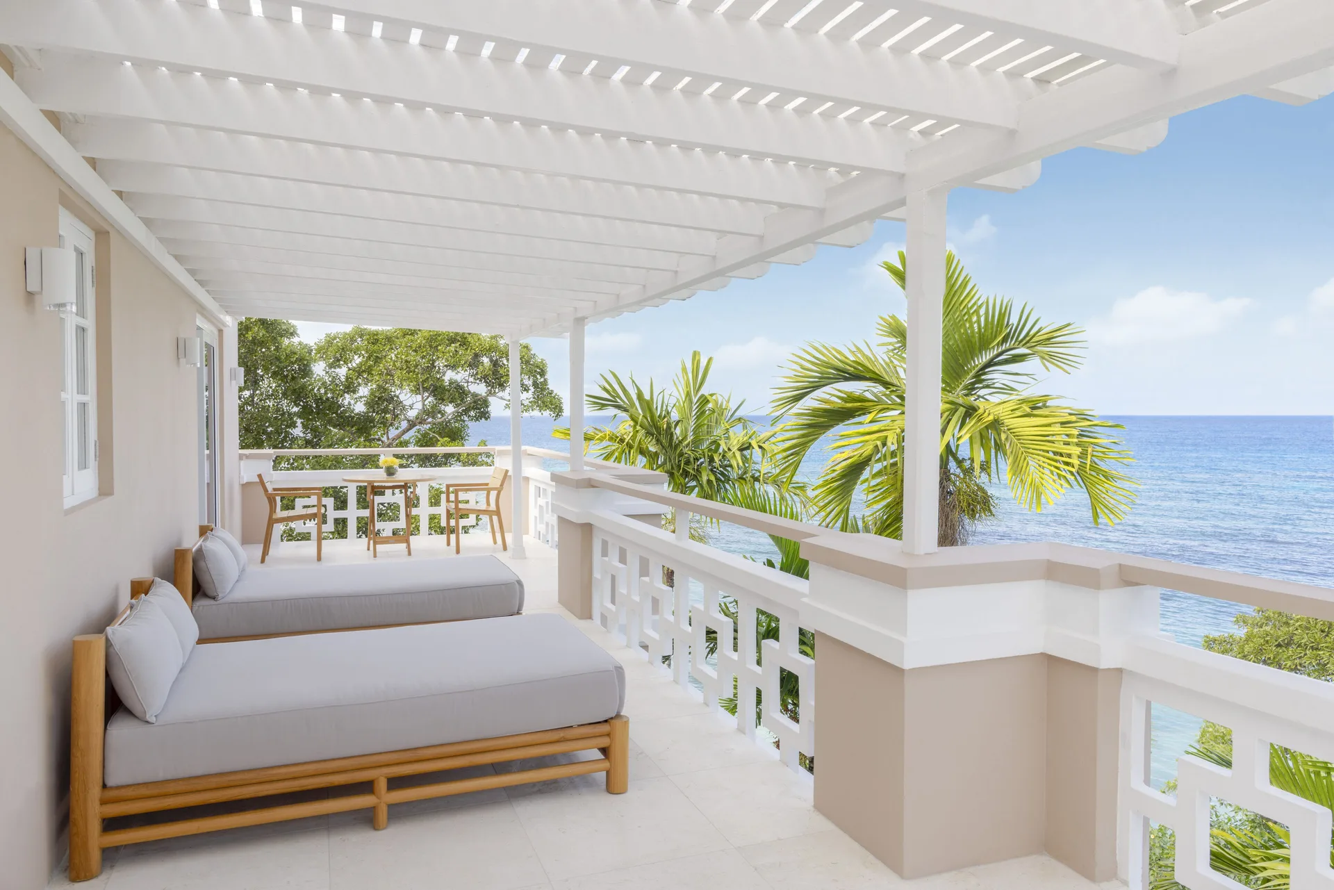 Penthouse Ocean Suite oceanfront balcony with loungers at Couples Sans Souci.