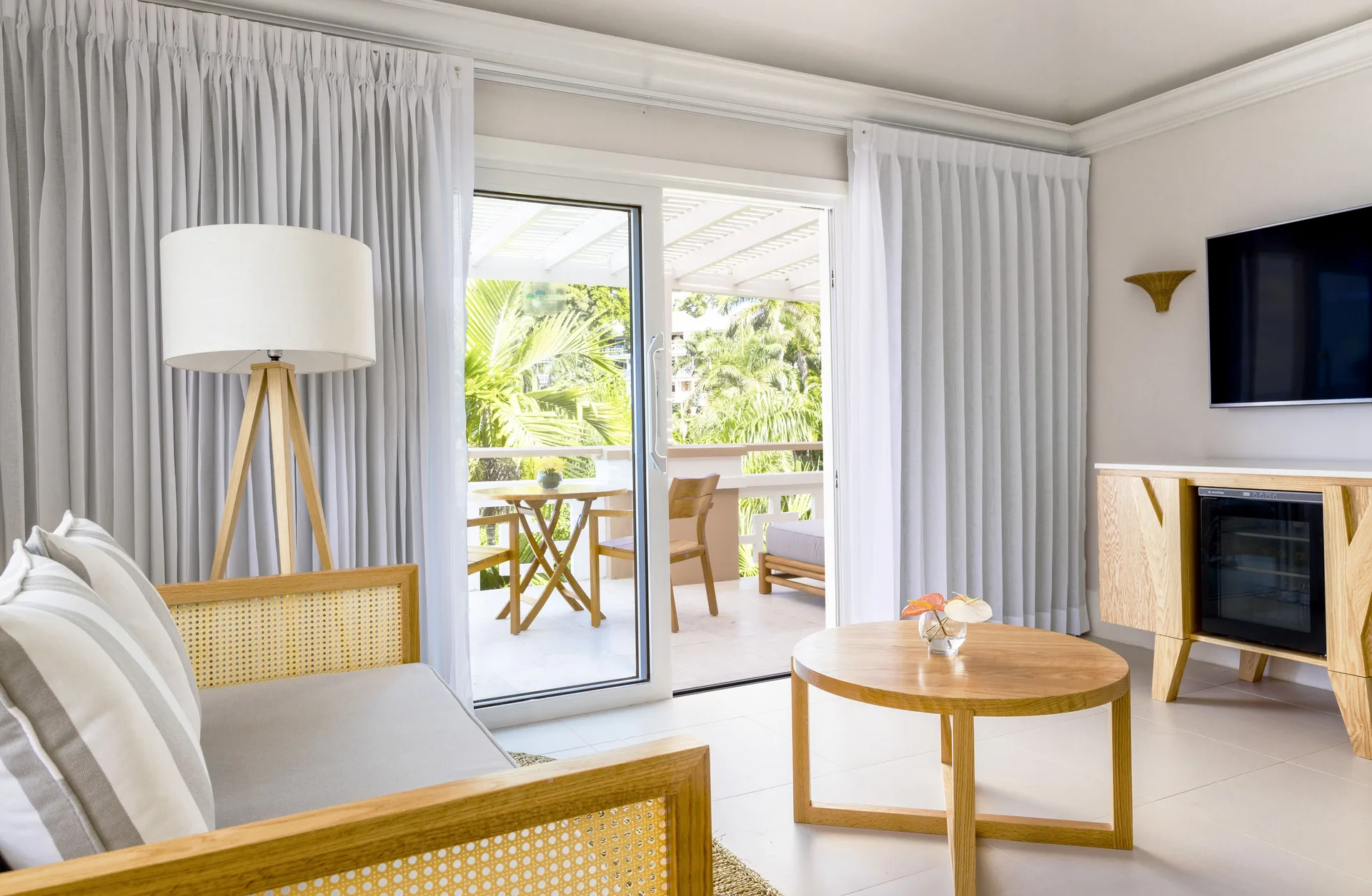 Penthouse Ocean Suite sitting area with balcony doors at Couples Sans Souci.