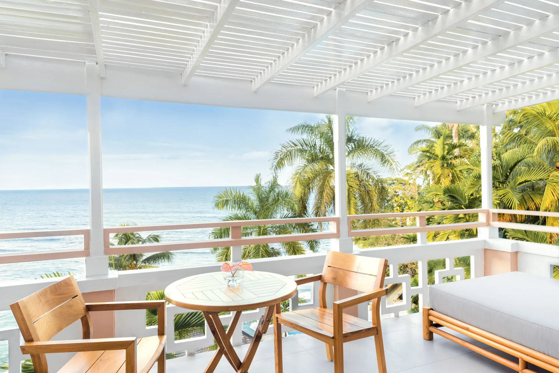 Premier Ocean Suite furnished balcony overlooking the ocean at Couples Sans Souci.