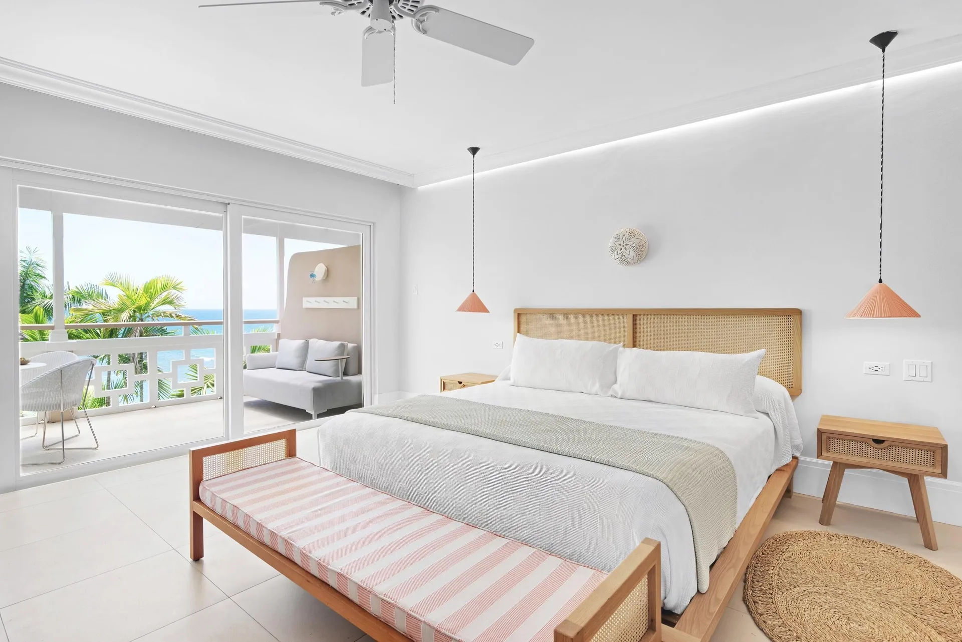 Premier Ocean Suite king bed with balcony doors at Couples Sans Souci.