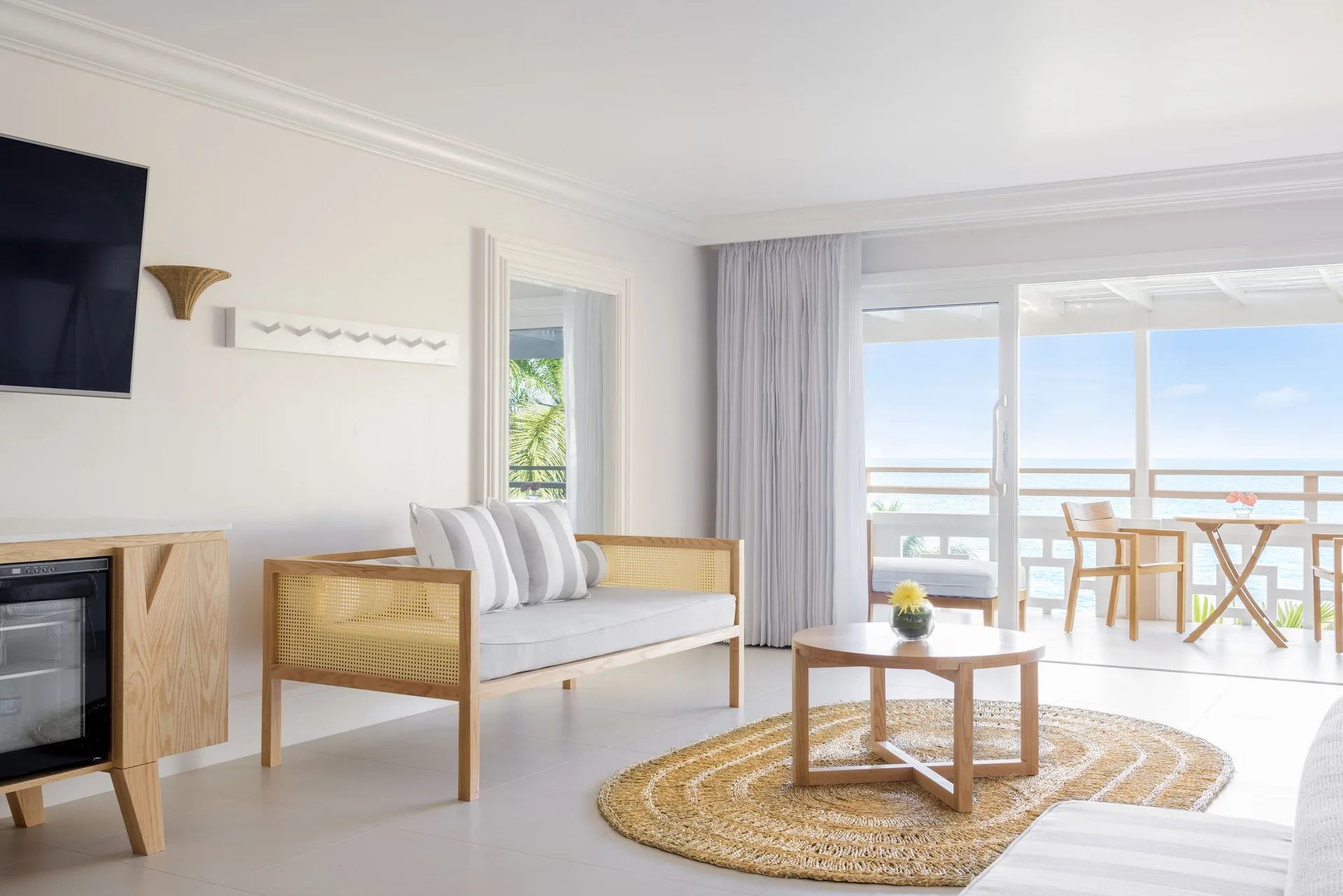 Premier Ocean Suite sitting area with balcony and sea view at Couples Sans Souci.