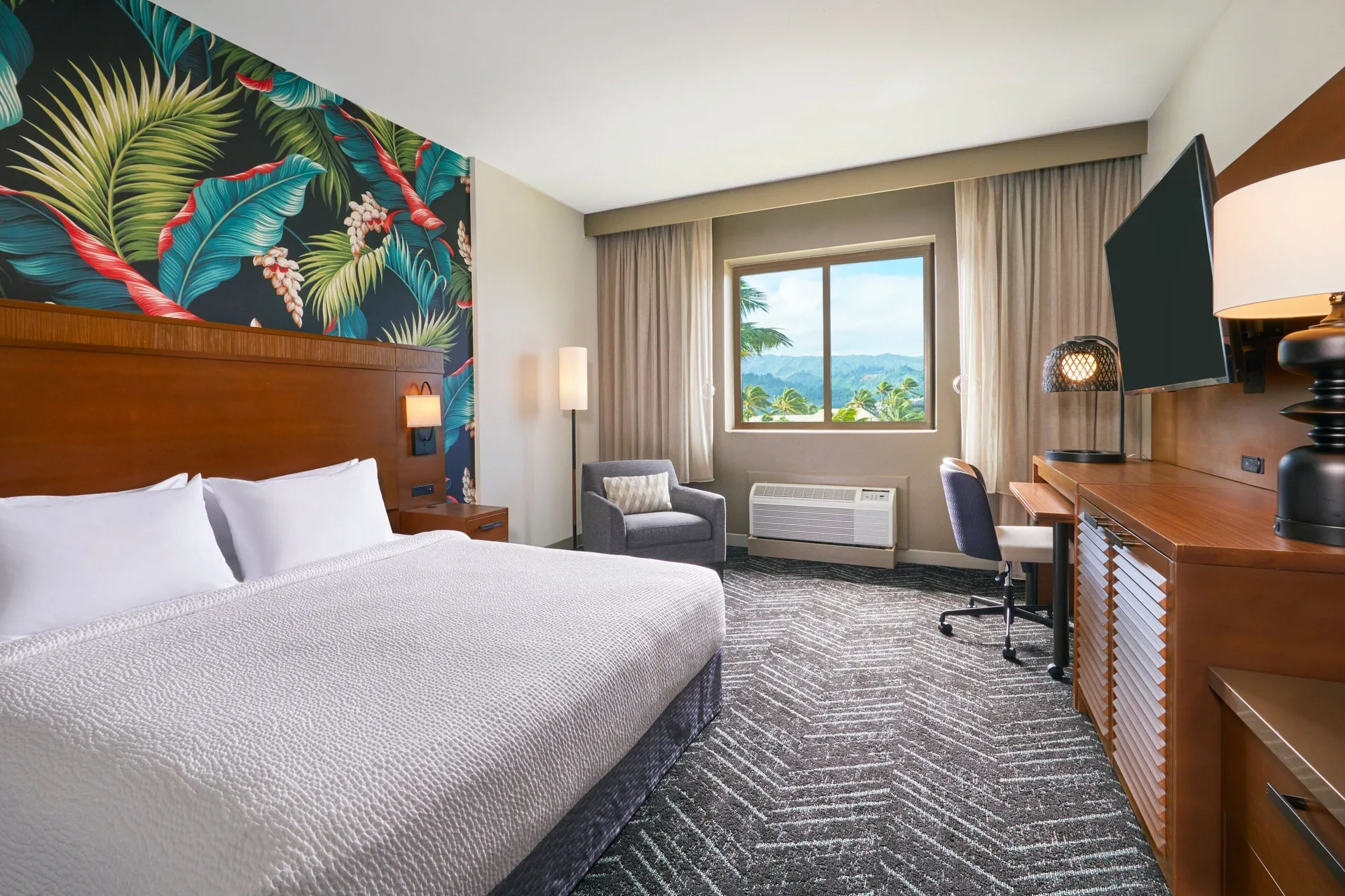 King guest room with mountain-facing window at Courtyard Oahu North Shore.