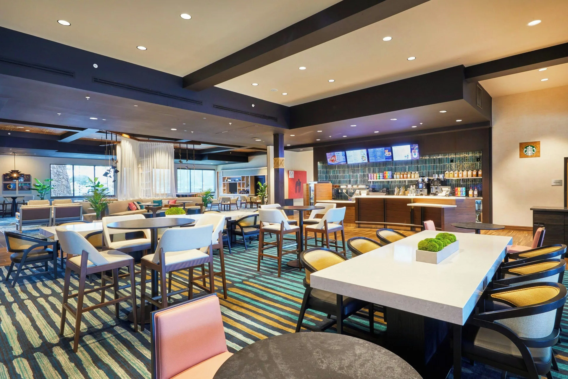 Open dining and lounge area with bar counter at Courtyard Oahu North Shore.