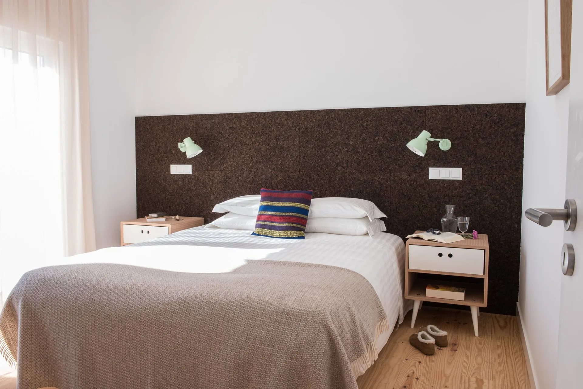 House 1 Bedroom at Craveiral Farmhouse with a double bed, cork headboard, nightstands and soft window light.