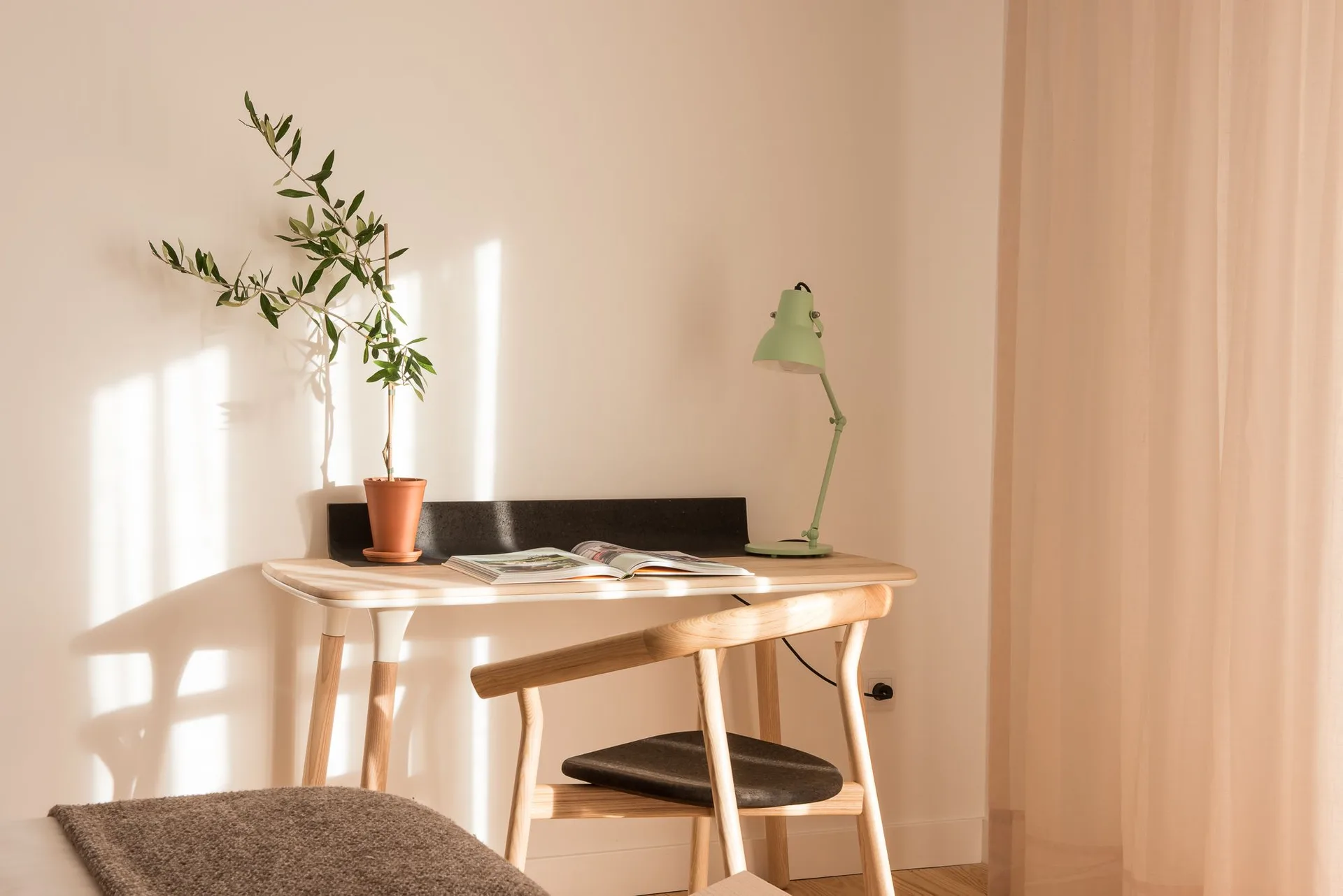 Studio desk by sheer curtains at Craveiral Farmhouse.