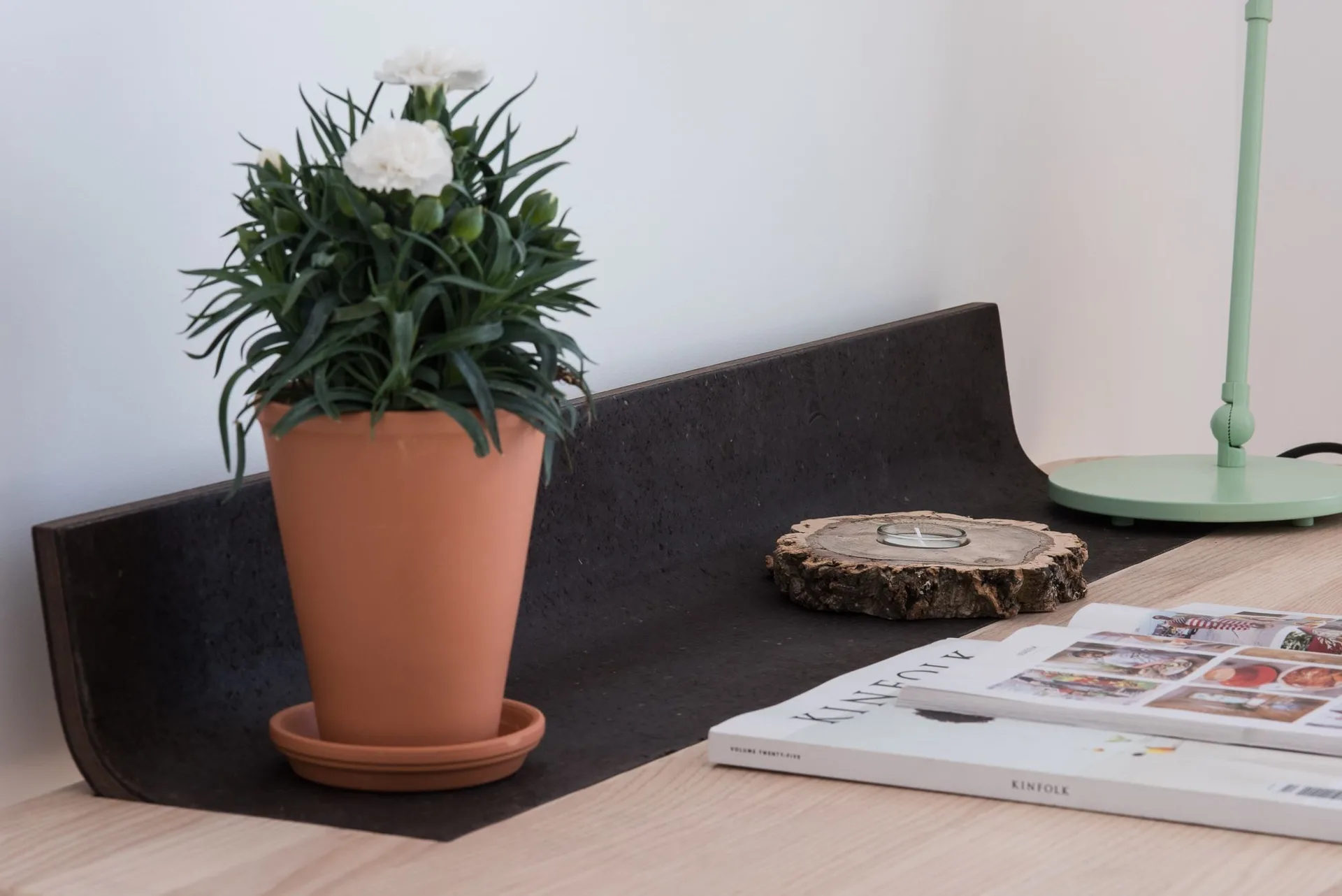 Studio desk detail with potted flowers at Craveiral Farmhouse.