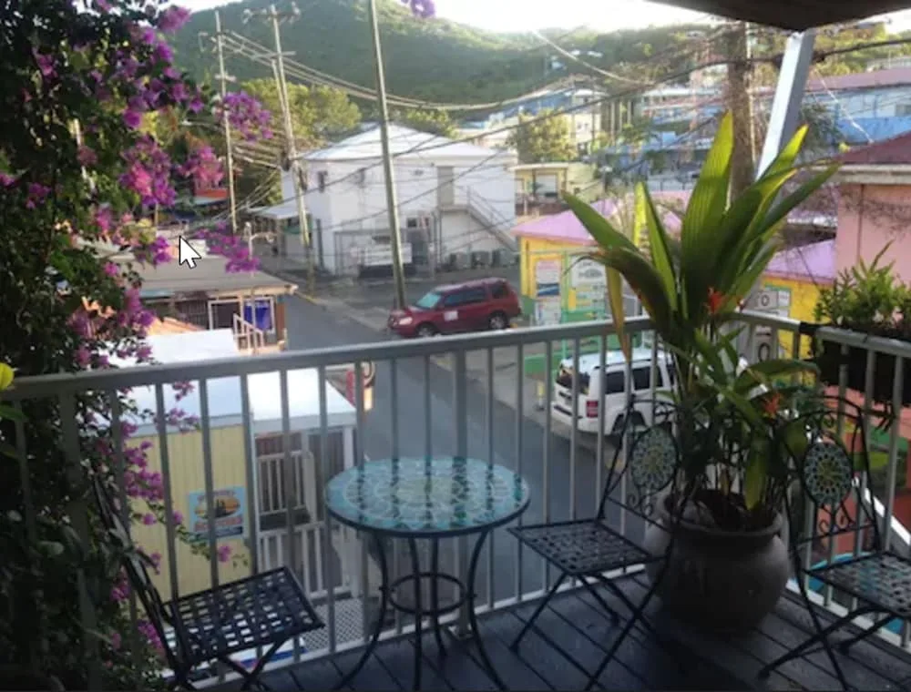Balcony seating and potted plants overlooking Cruz Bay Boutique Hotel streets at Cruz Bay Boutique Hotel.