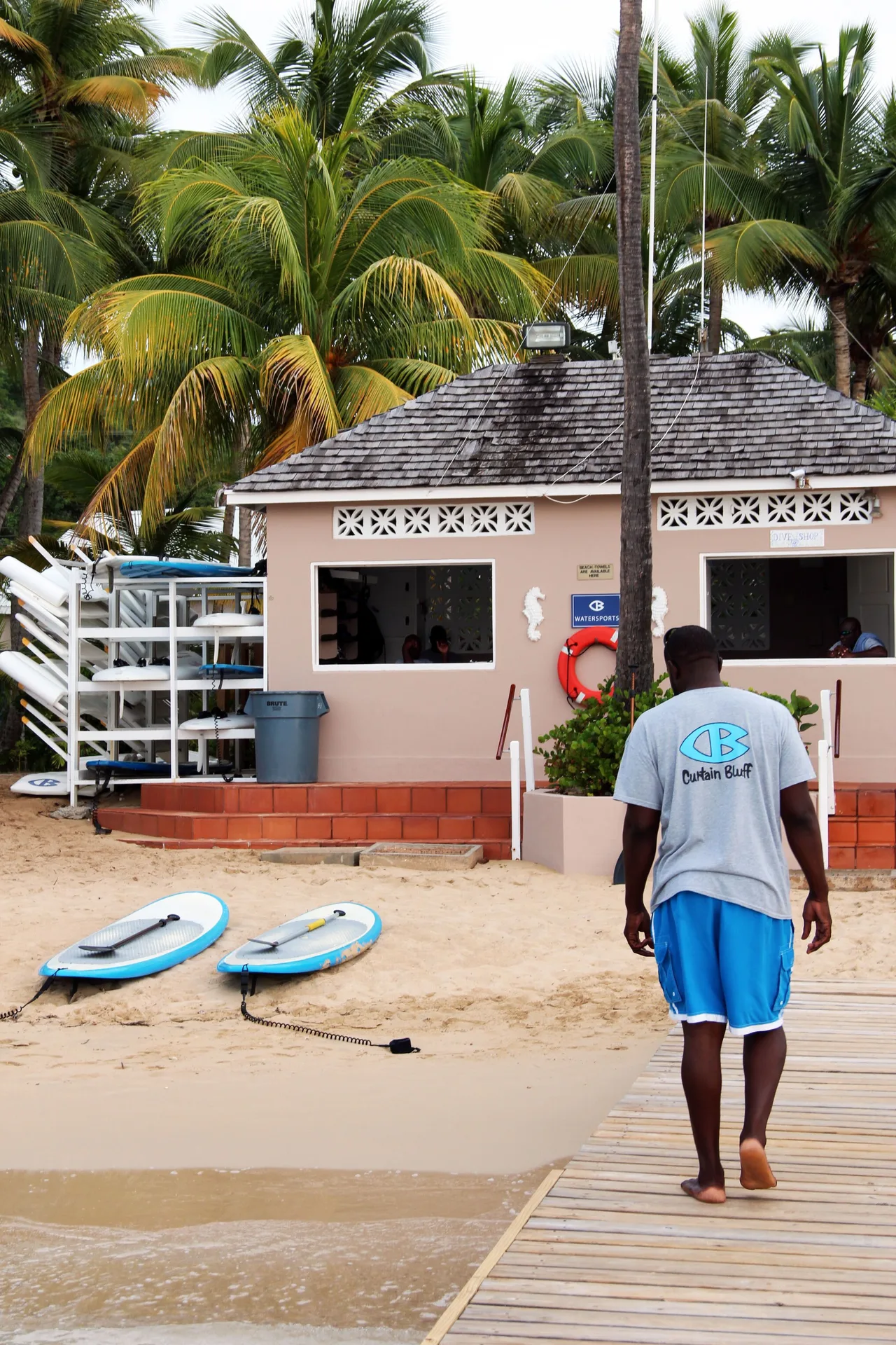 Watersports hut with paddleboards on the beach at Curtain Bluff Resort.