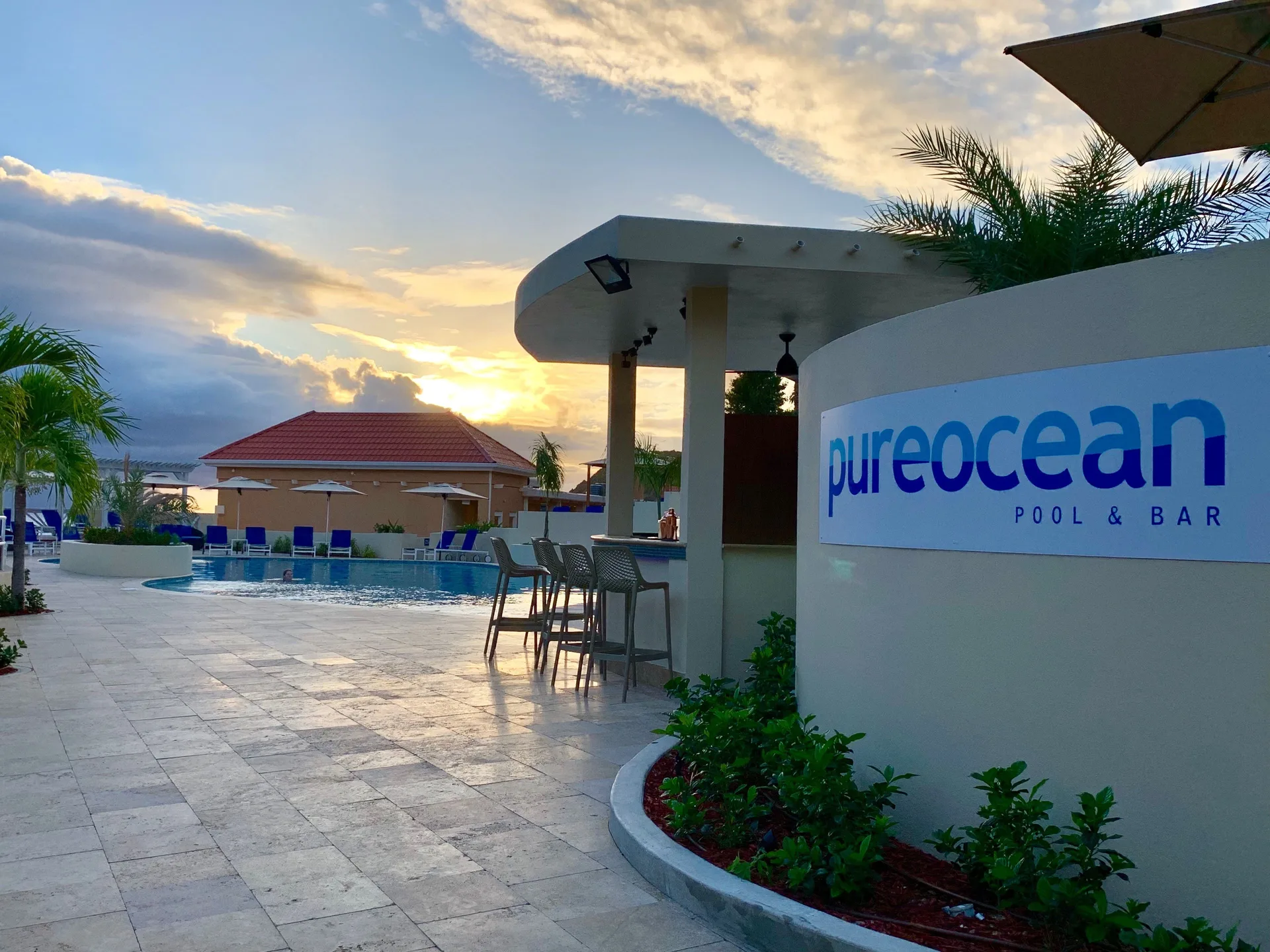 pureocean Pool Bar sign beside the pool at Divi Little Bay Beach Resort.
