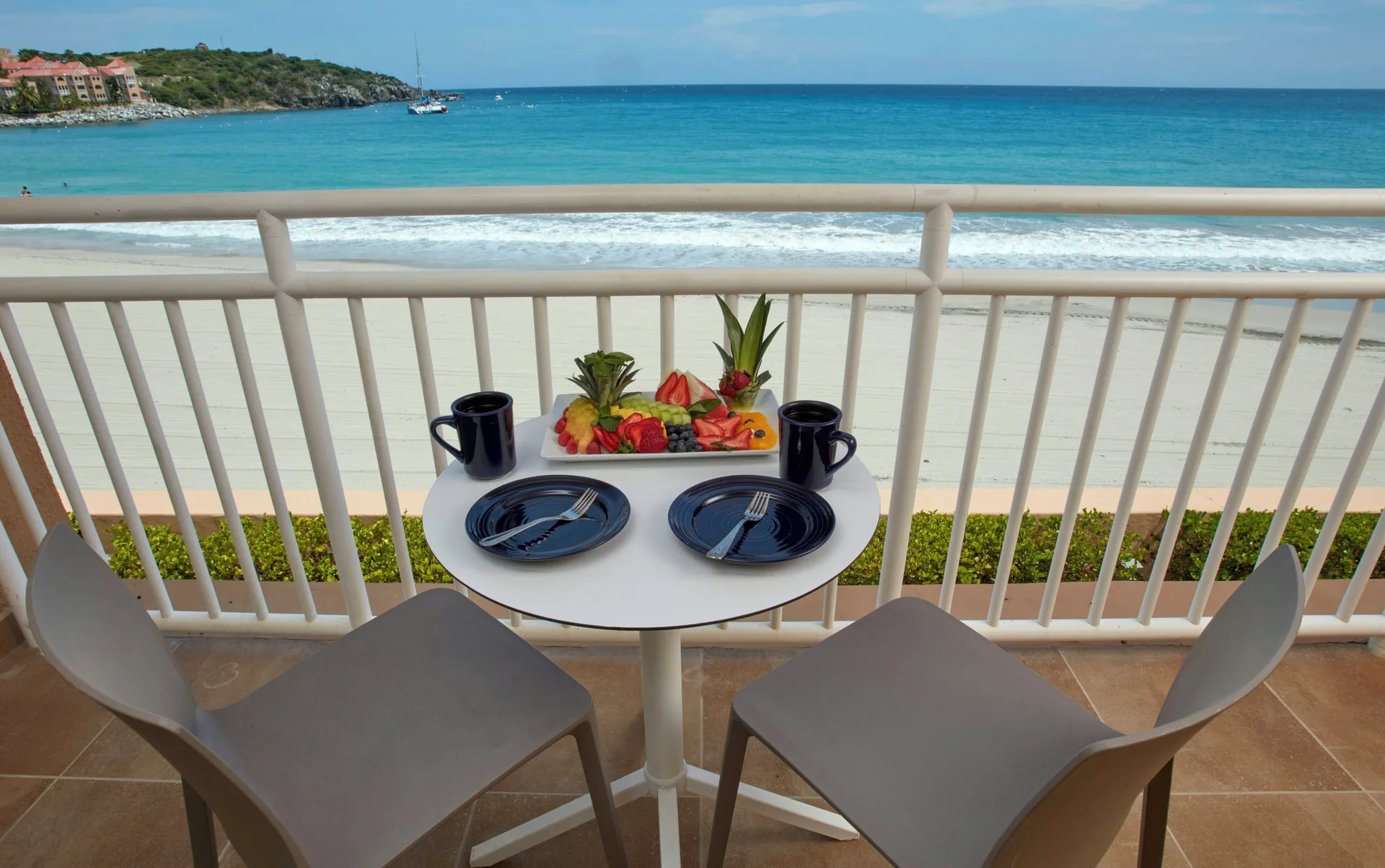 Studio Suite balcony table overlooking the beach at Divi Little Bay Beach Resort.