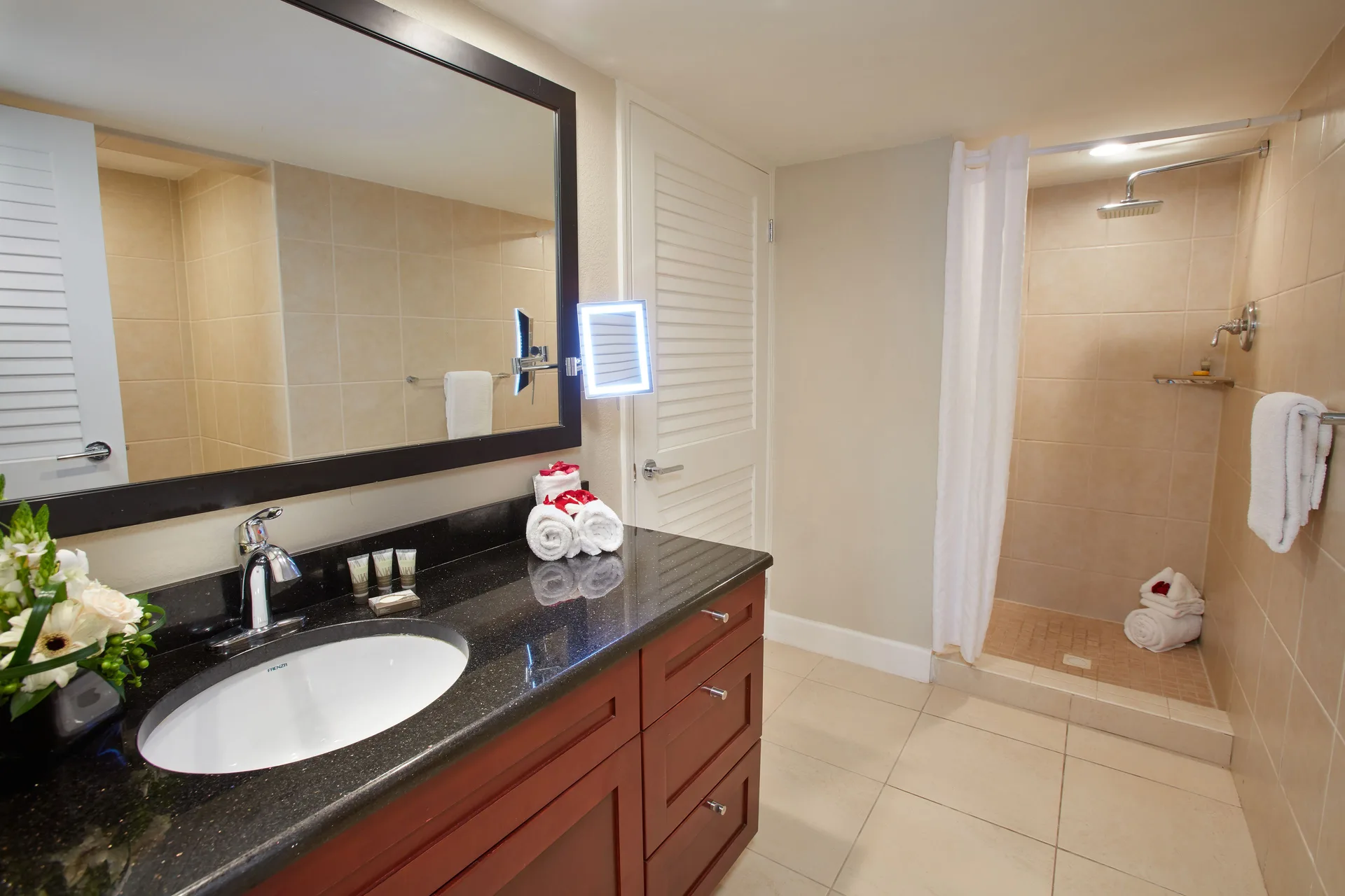 One Bedroom Suite vanity and tiled shower at Divi Little Bay Beach Resort.