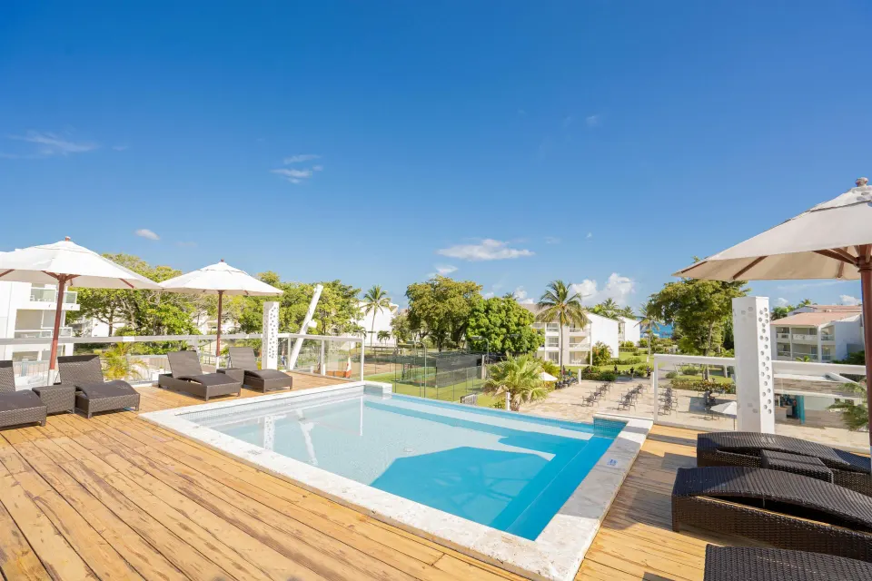 Elevated plunge pool deck with loungers and resort views at Emotions by Hodelpa Puerto Plata.